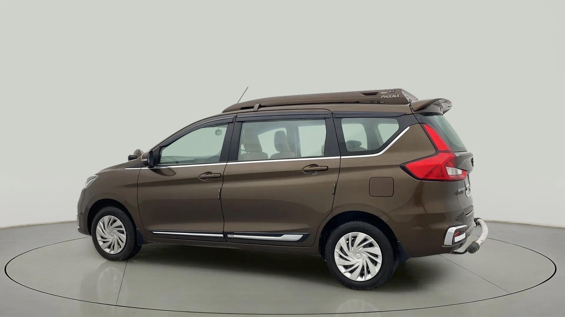 Side view of a Pearl Metallic Dignity Brown Maruti Suzuki Ertiga