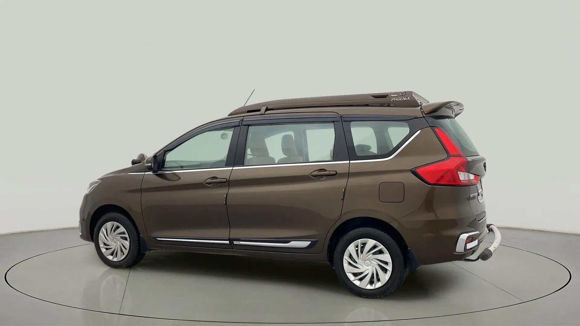 Side view of a Pearl Metallic Dignity Brown Maruti Suzuki Ertiga