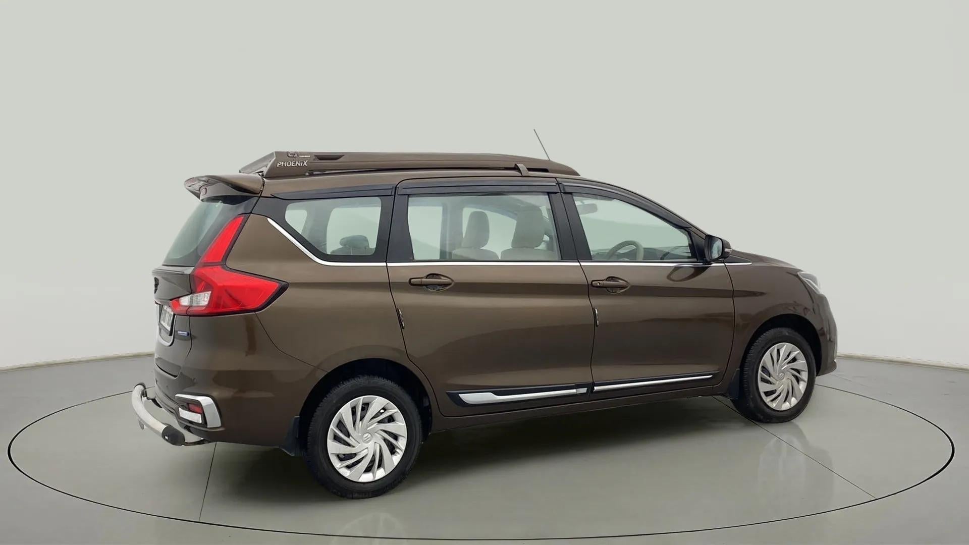 Rear three-quarter of a Pearl Metallic Dignity Brown Maruti Suzuki Ertiga