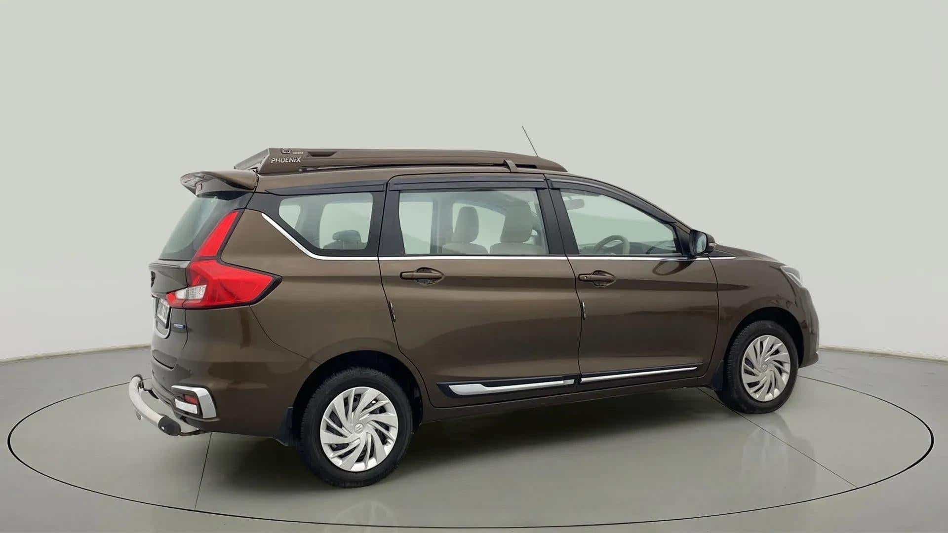 Rear three-quarter of a Pearl Metallic Dignity Brown Maruti Suzuki Ertiga