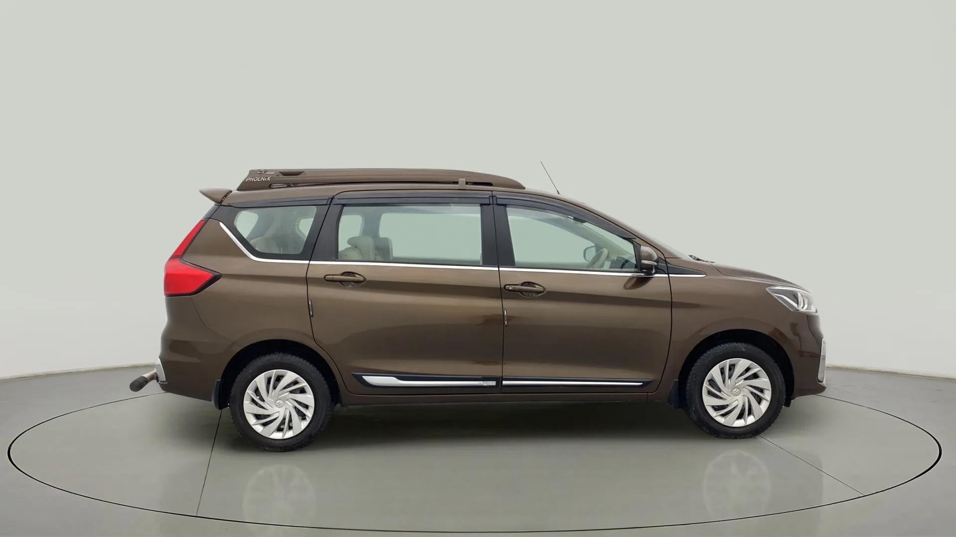 Side view of a Pearl Metallic Dignity Brown Maruti Suzuki Ertiga
