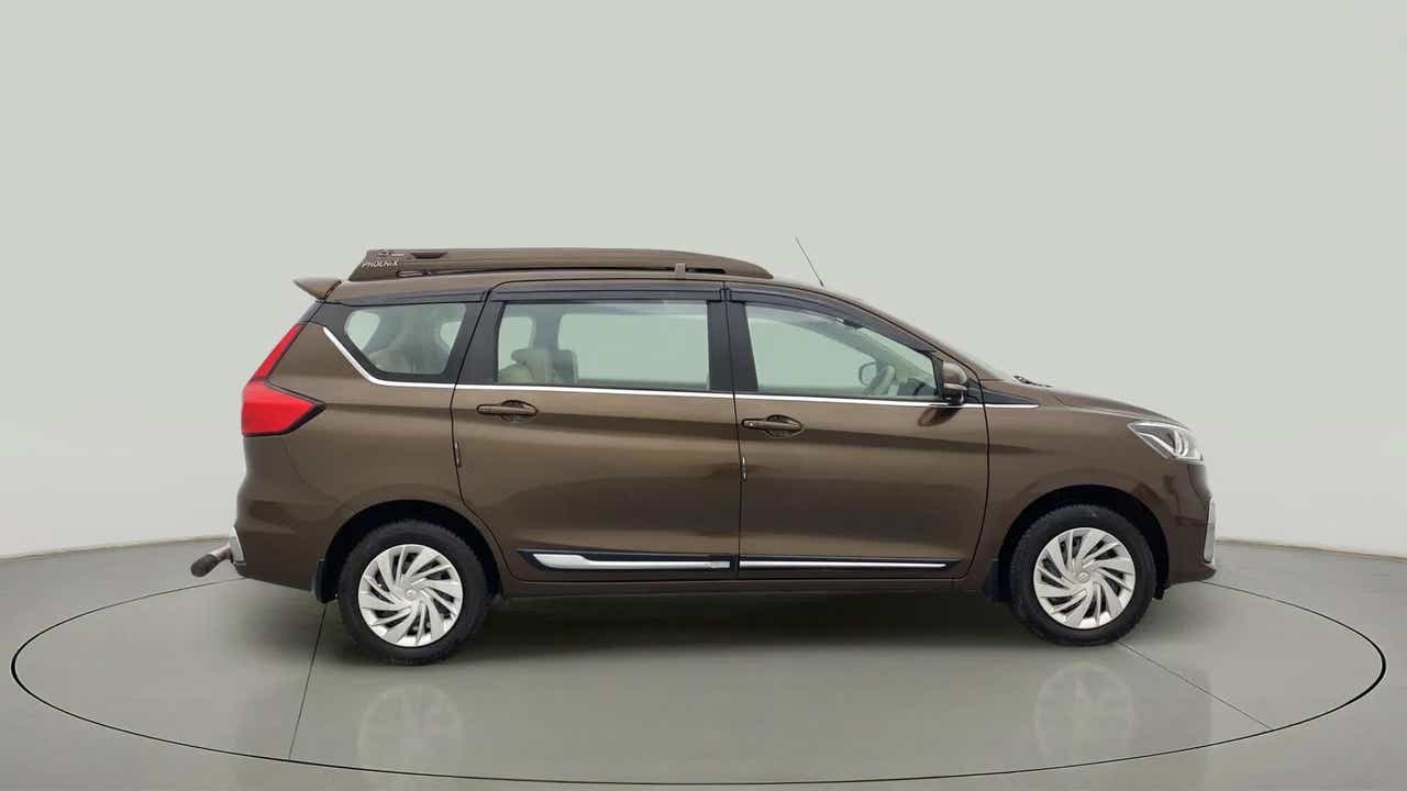 Side view of a Pearl Metallic Dignity Brown Maruti Suzuki Ertiga