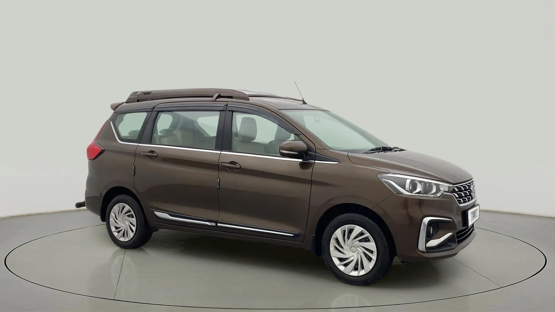 Side view of a Pearl Metallic Dignity Brown Maruti Suzuki Ertiga