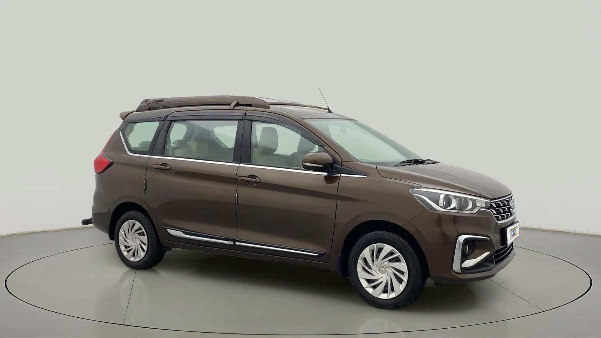 Side view of a Pearl Metallic Dignity Brown Maruti Suzuki Ertiga