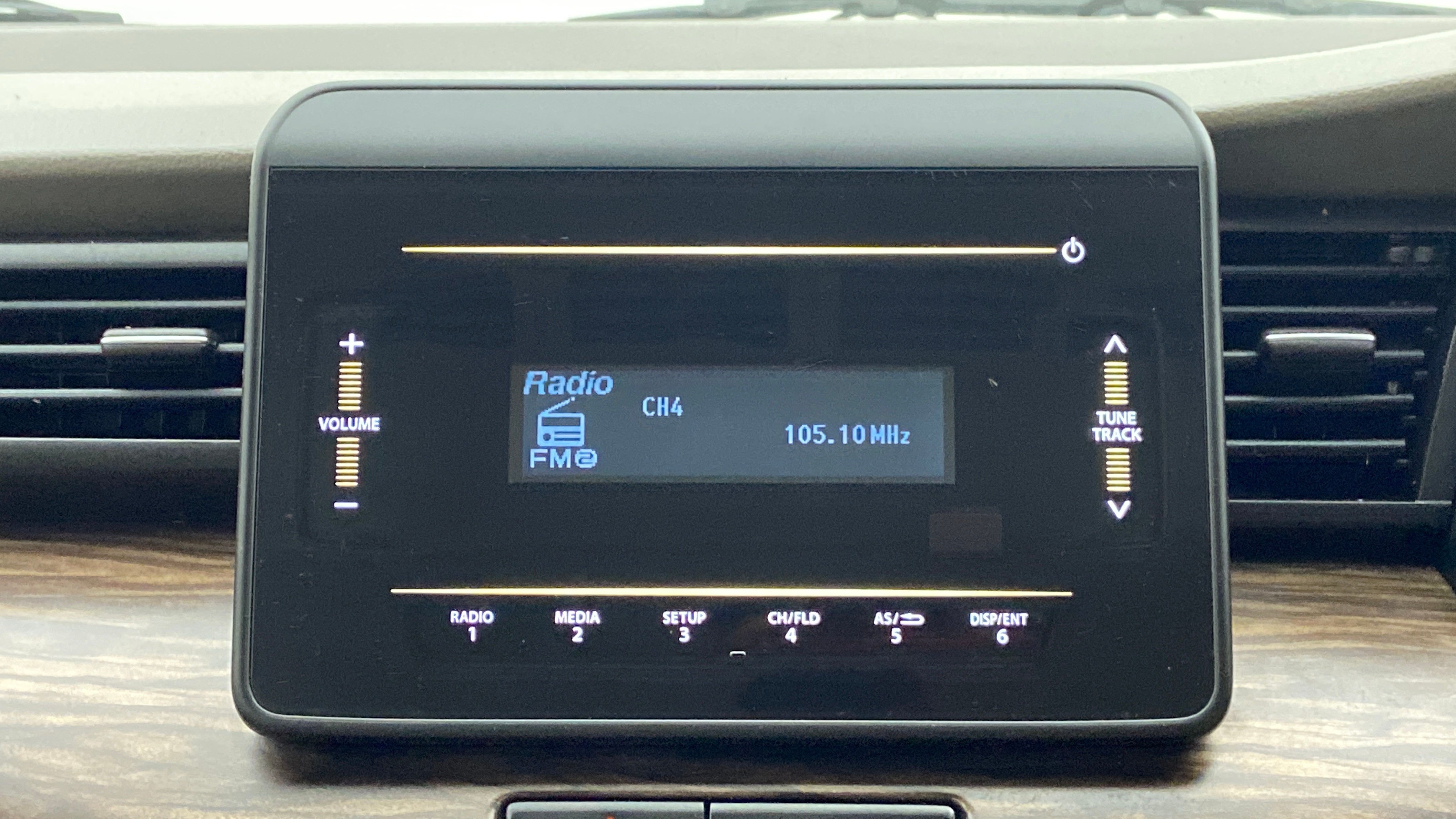 Car audio display of a Maruti Suzuki Ertiga showing radio controls
