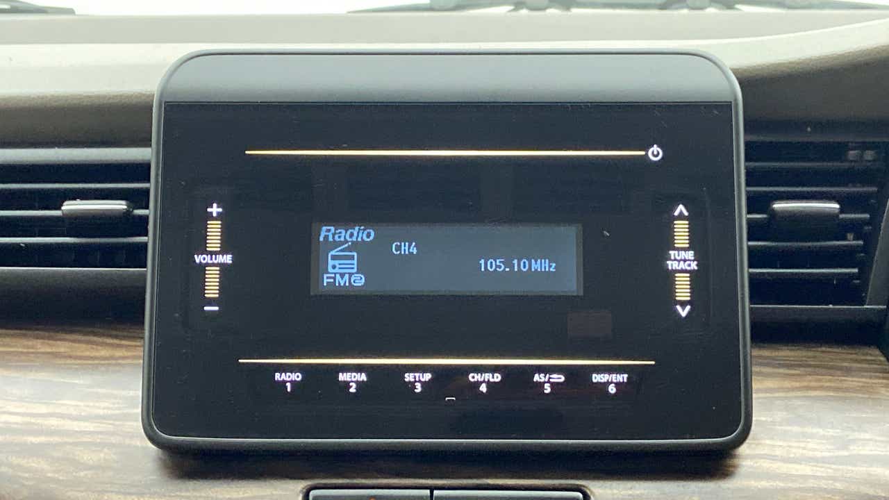 Car audio display of a Maruti Suzuki Ertiga showing radio controls
