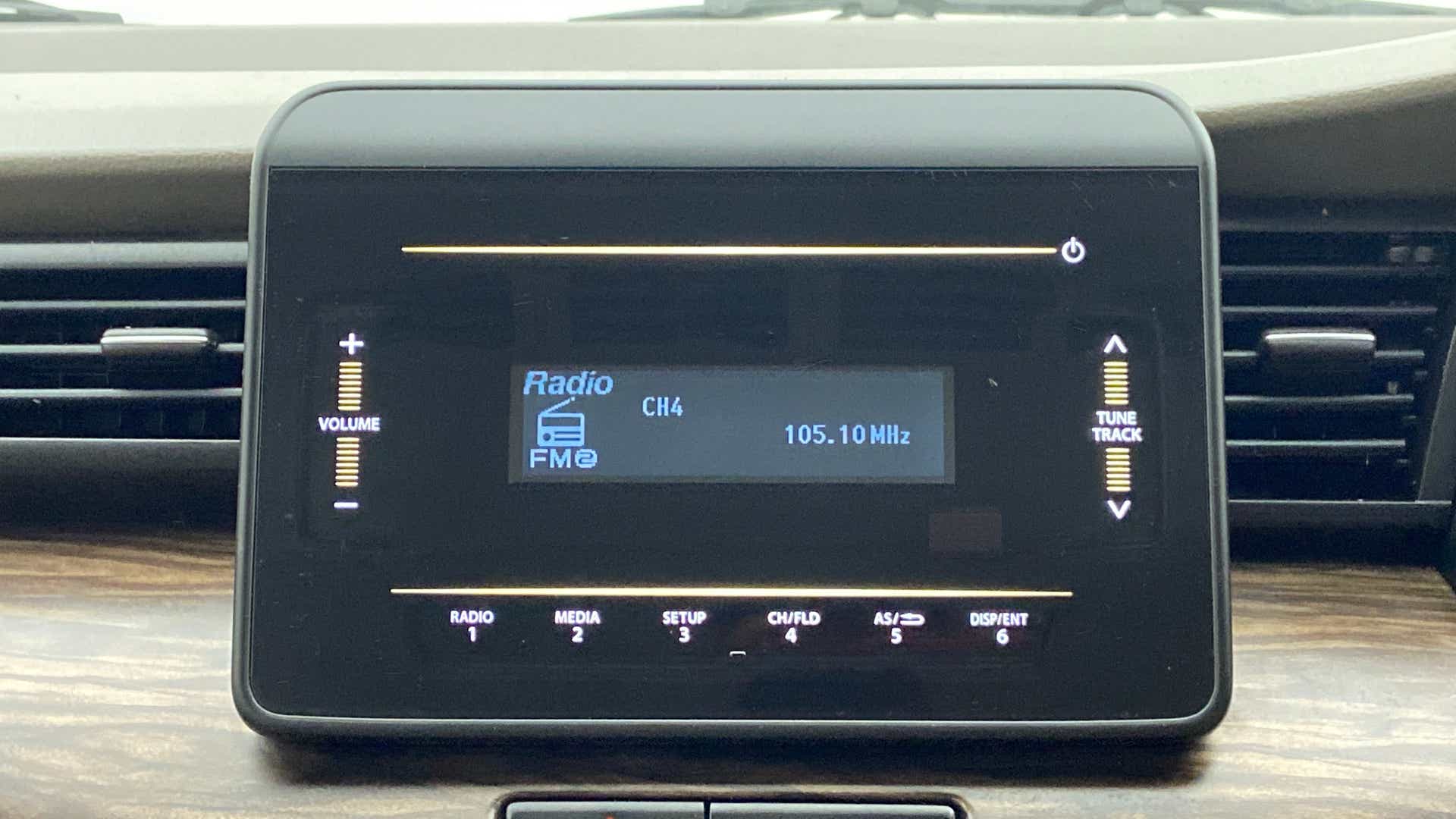Car audio display of a Maruti Suzuki Ertiga showing radio controls