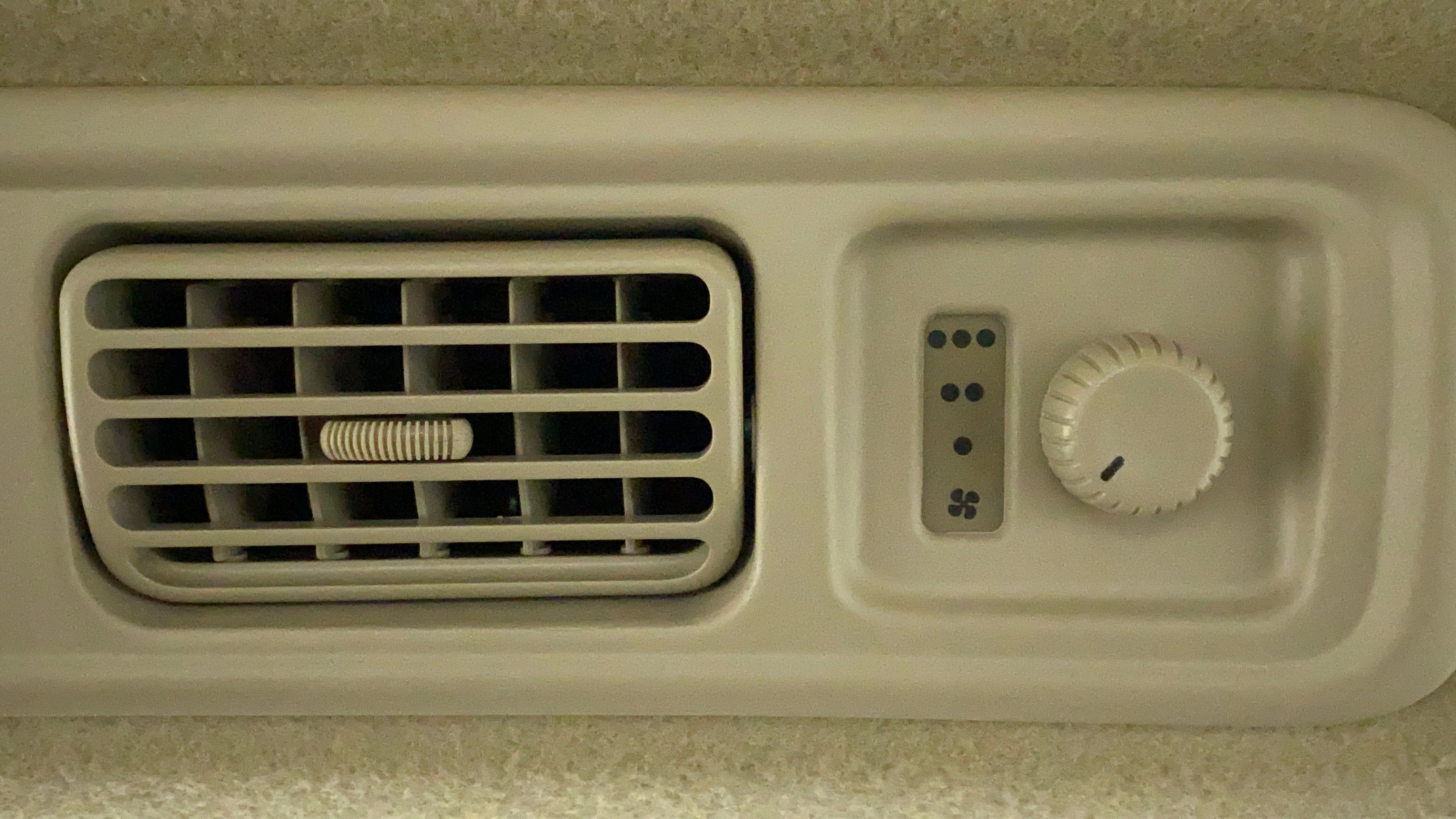 Close-up of the air conditioning vent and control knob of a Maruti Suzuki Ertiga
