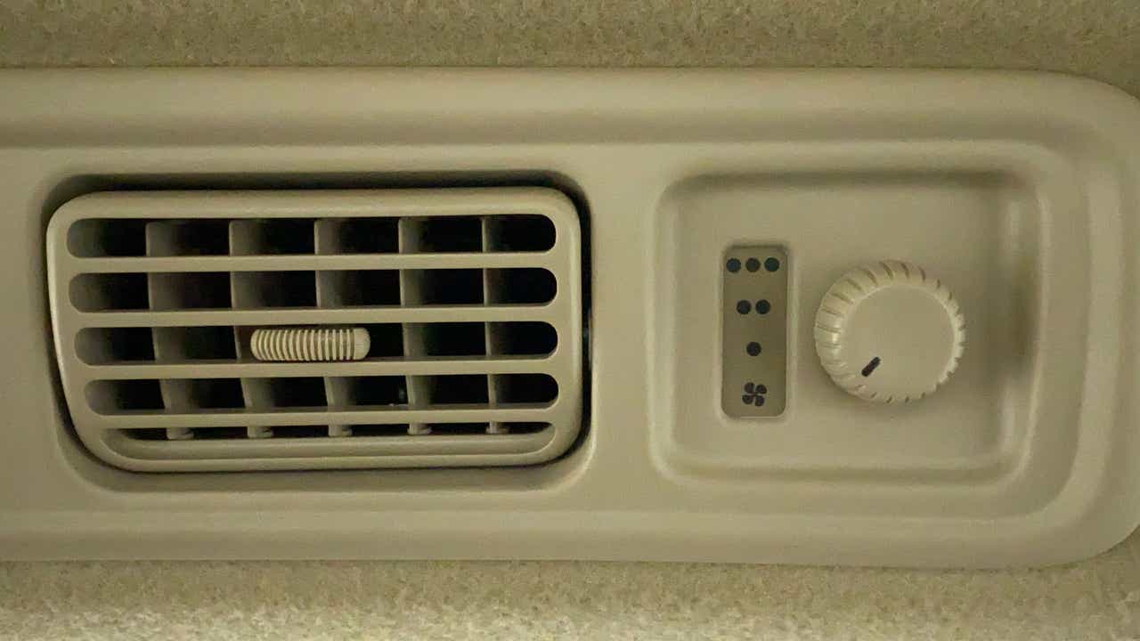 Close-up of the air conditioning vent and control knob of a Maruti Suzuki Ertiga