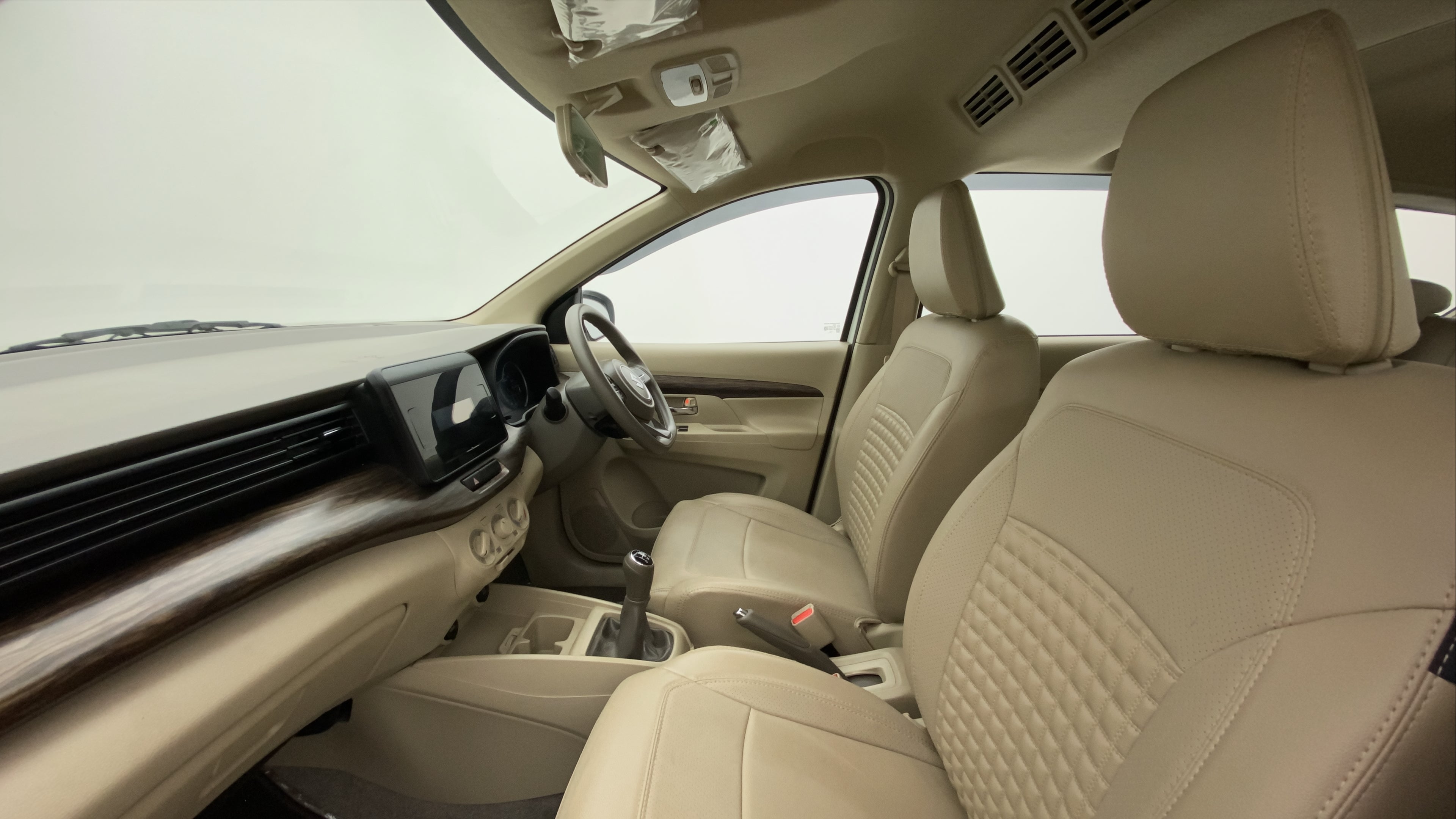 Interior dashboard and front seats of a Maruti Suzuki Ertiga