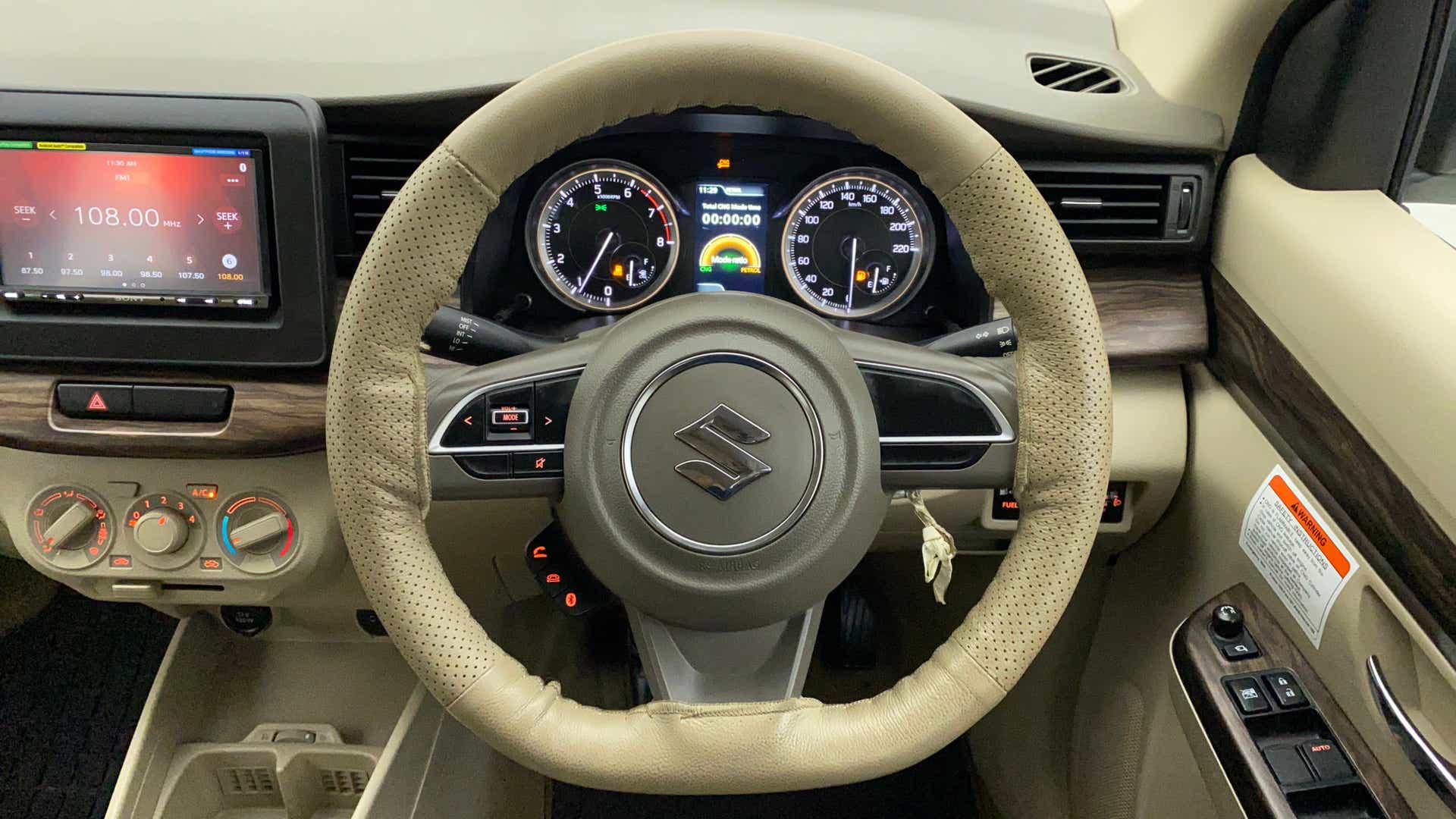 Interior dashboard and steering wheel of a Maruti Suzuki Ertiga