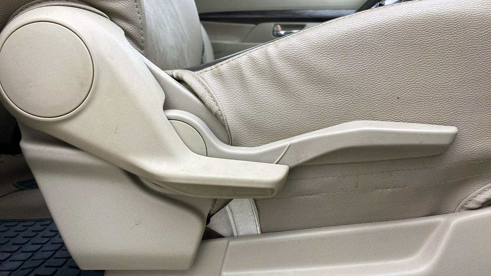 Side view of a Maruti Suzuki Ertiga car seat adjuster lever