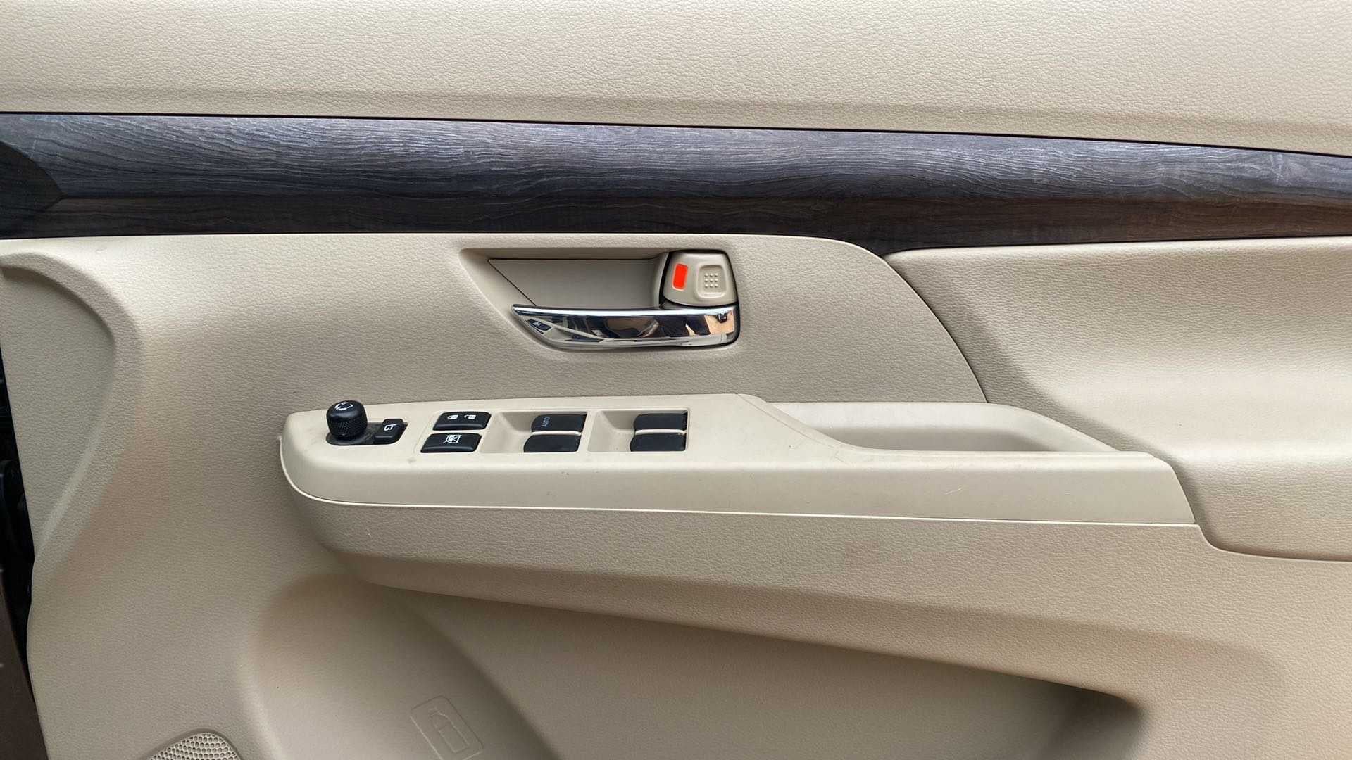 Front left door panel and controls of a Maruti Suzuki Ertiga
