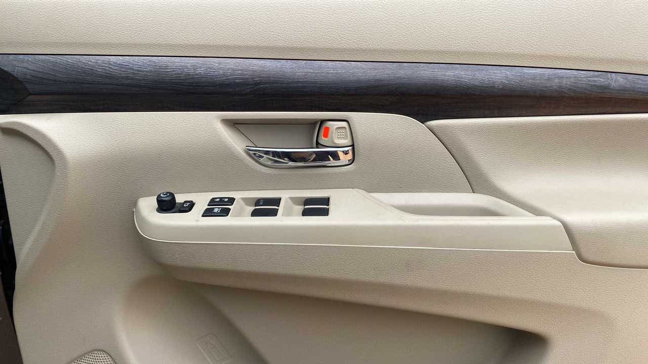 Front left door panel and controls of a Maruti Suzuki Ertiga