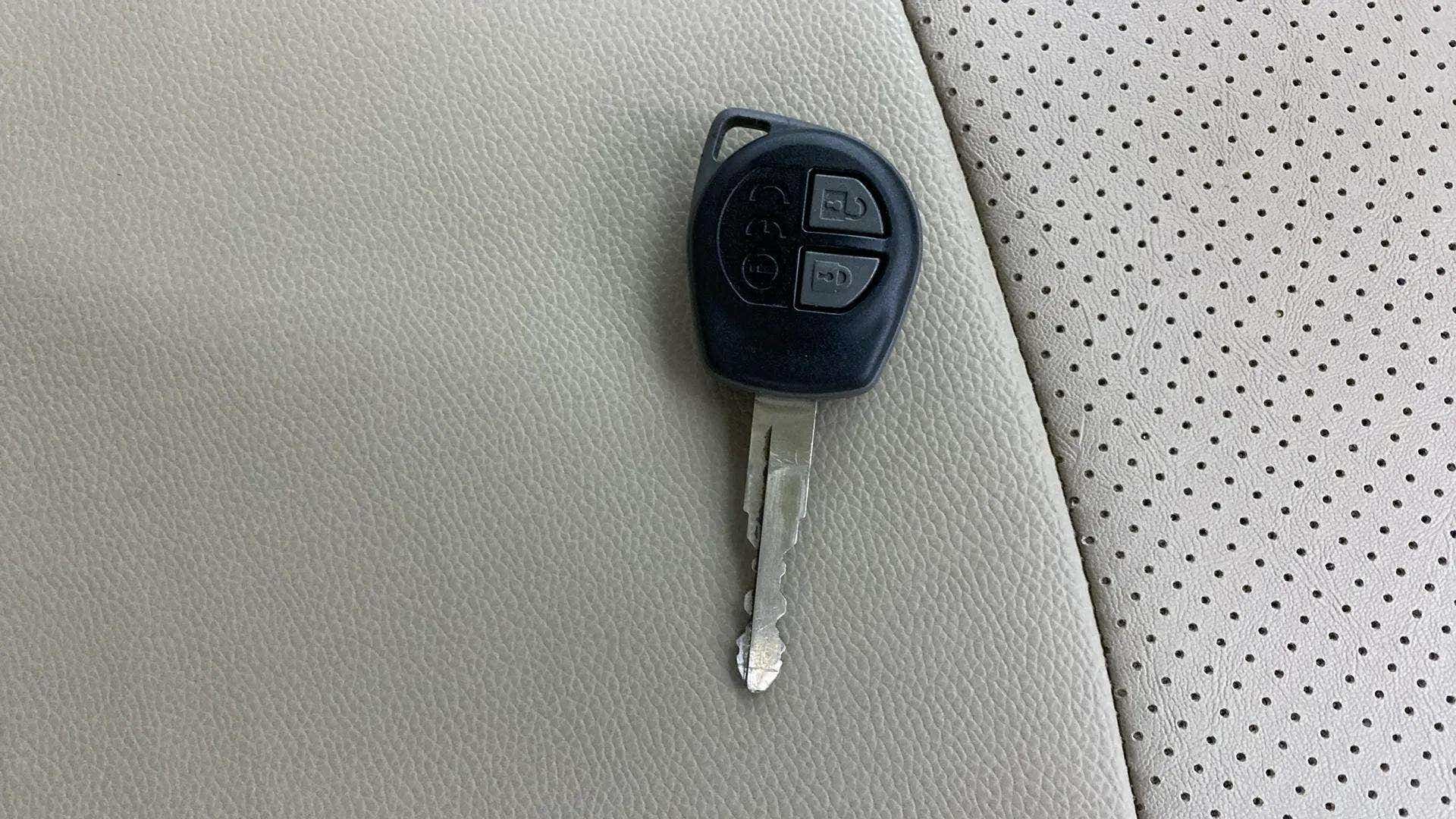 Car key fob on maruti suzuki ertiga seat upholstery