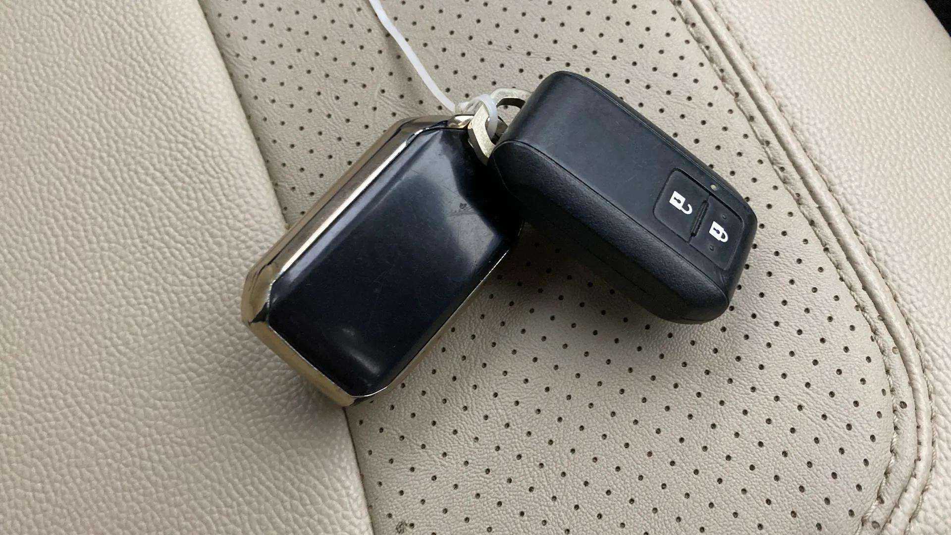 Close-up of a smart key fob on the seat of a Maruti Suzuki Ertiga