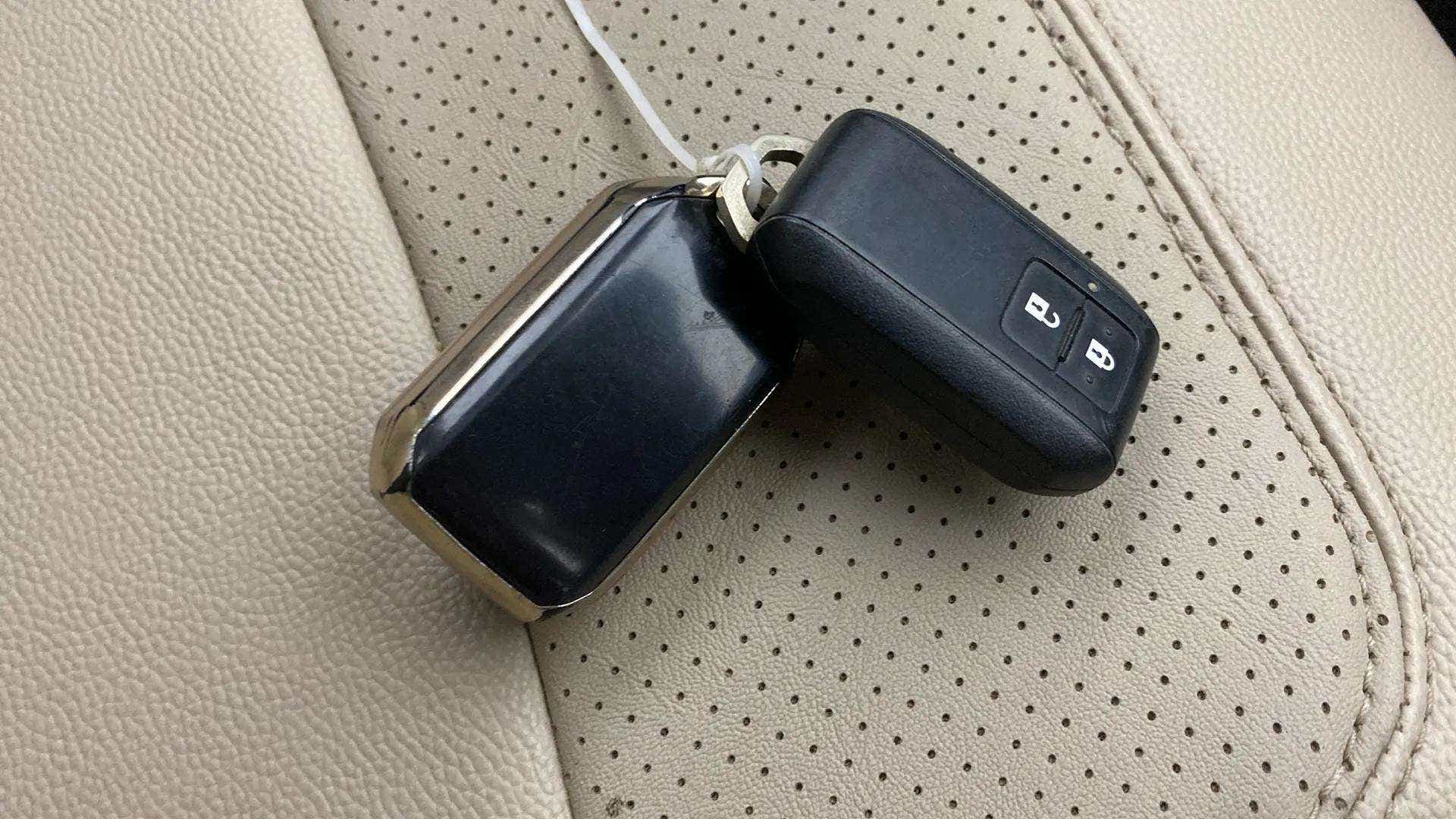 Close-up of a smart key fob on the seat of a Maruti Suzuki Ertiga