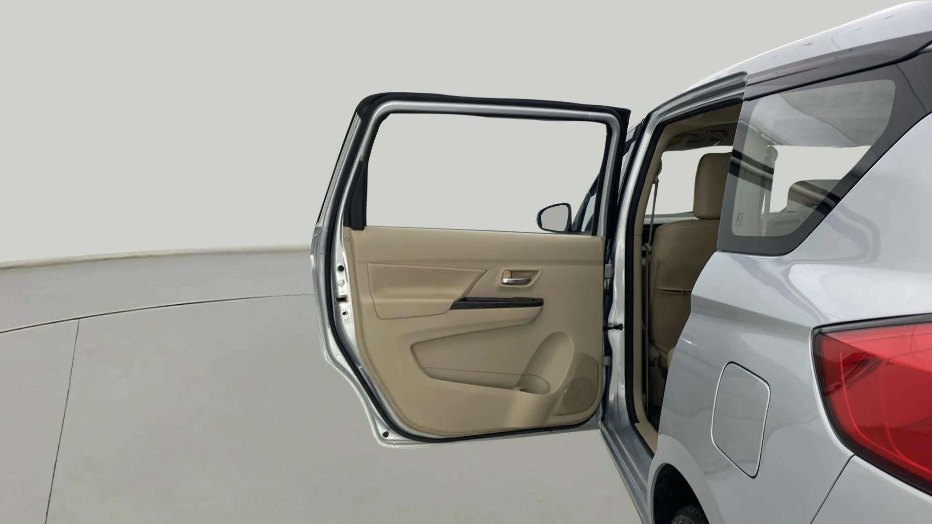 Rear left door open view of a Maruti Suzuki Ertiga
