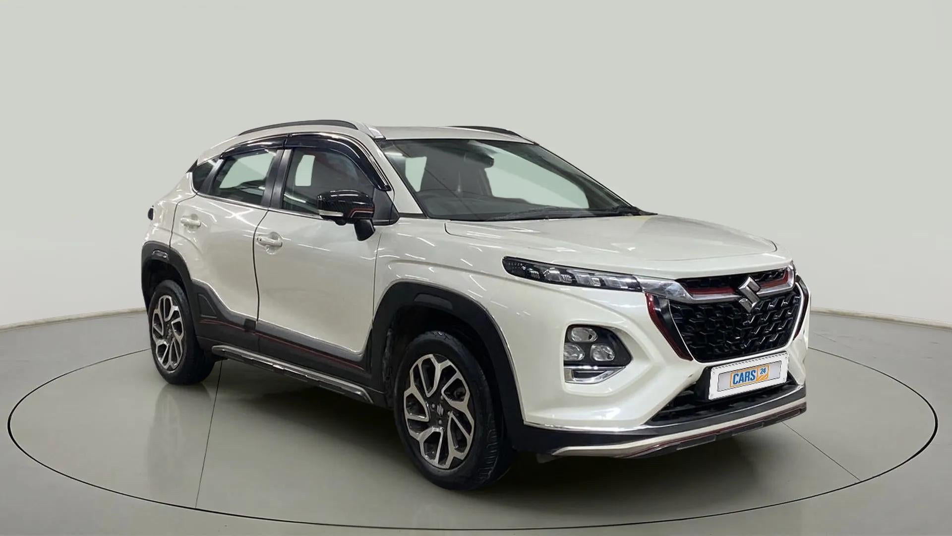 Front three-quarter view of a arctic white Maruti Suzuki FRONX