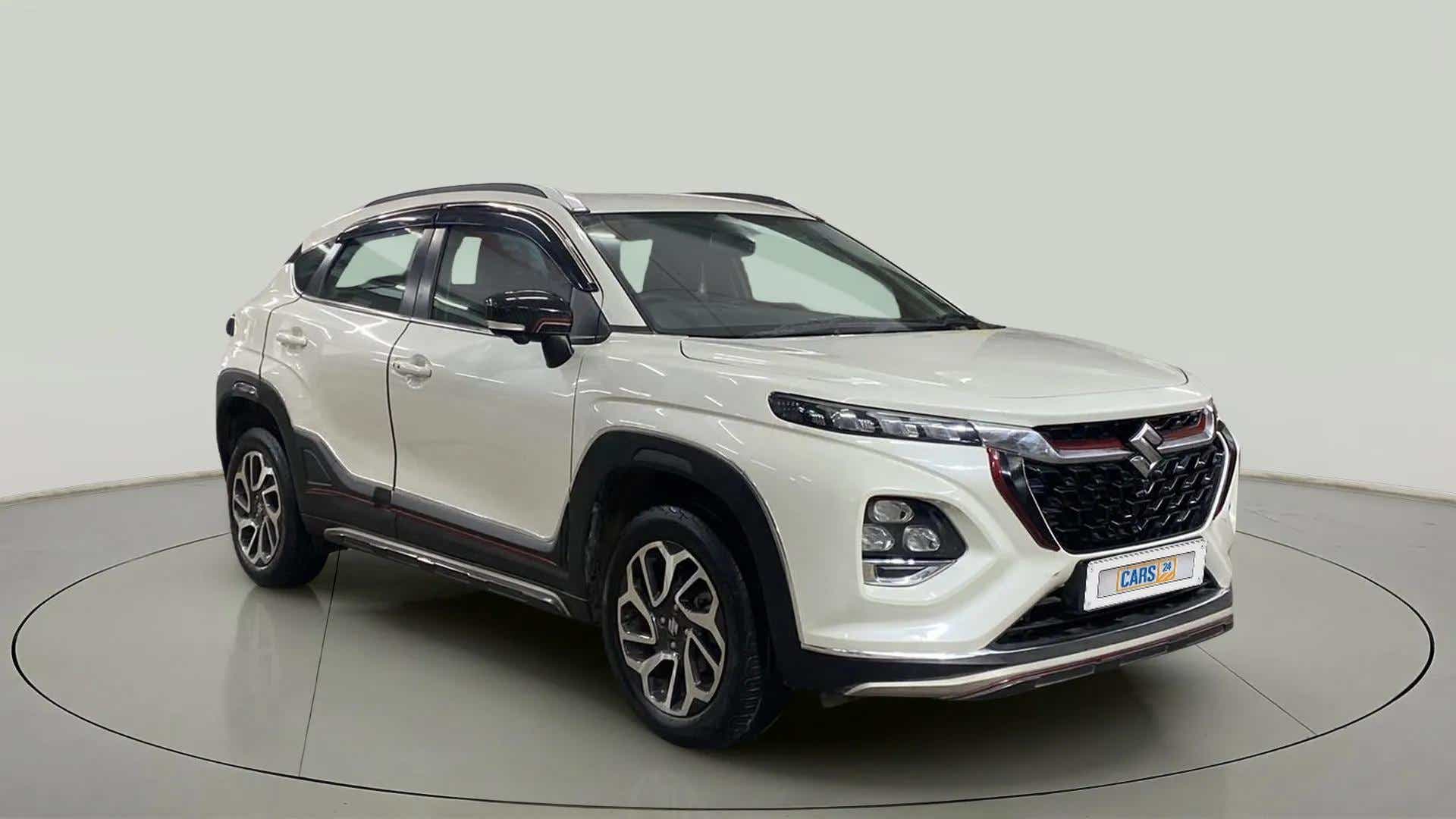 Front three-quarter view of a arctic white Maruti Suzuki FRONX