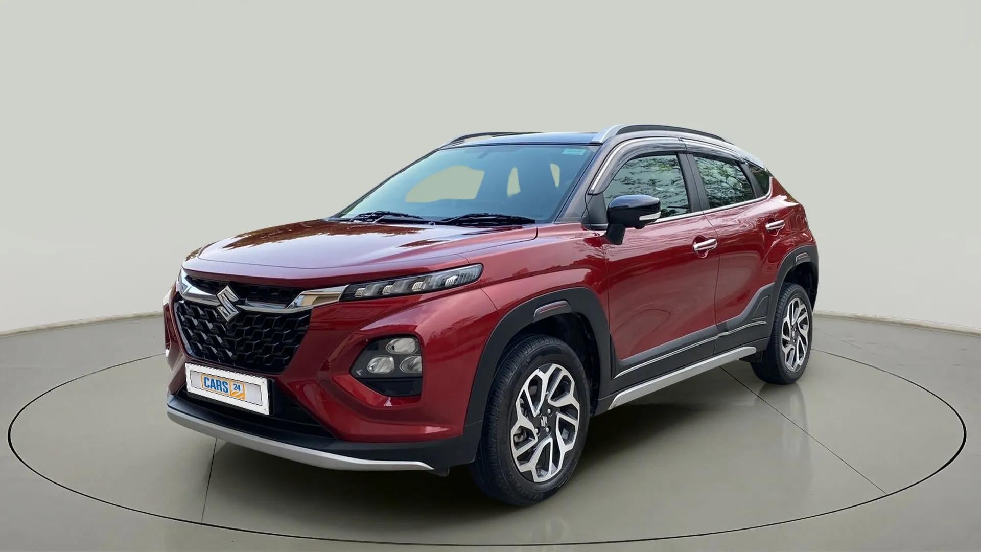 Front three-quarter view of a Opulent Red Maruti Suzuki FRONX