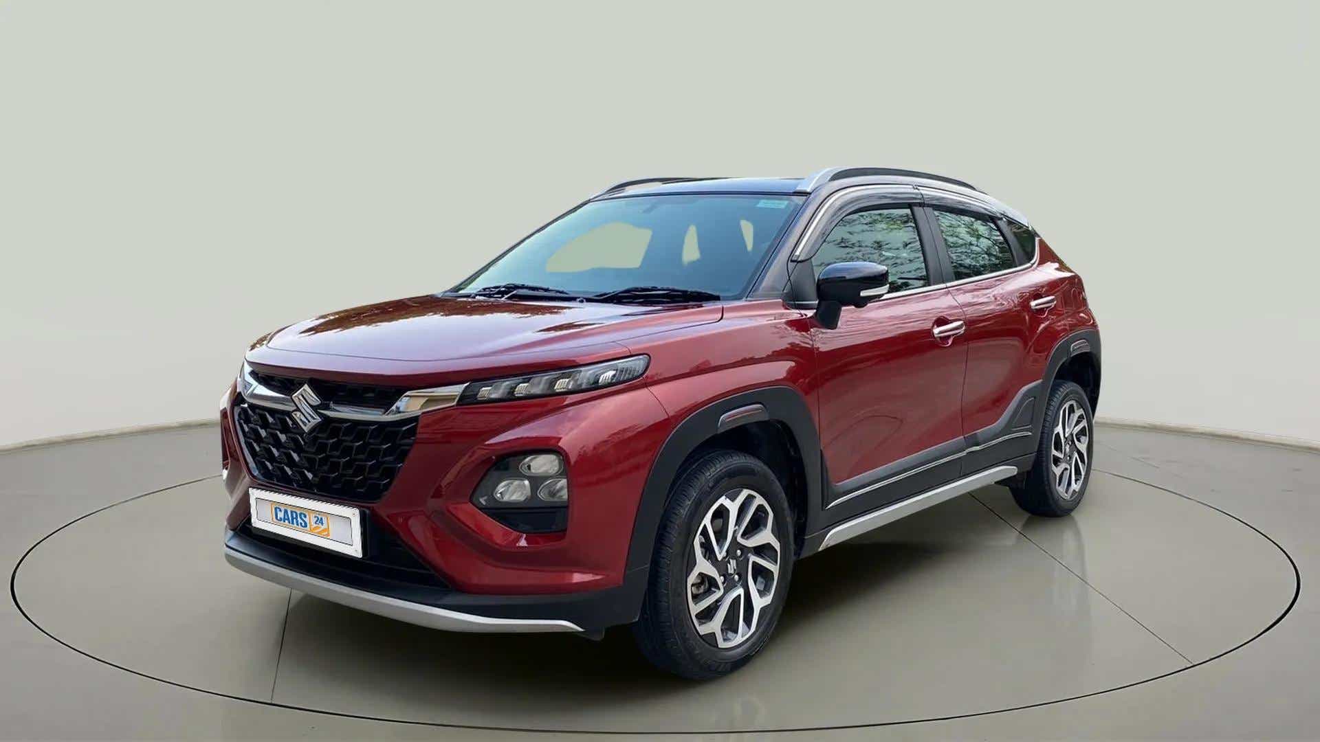 Front three-quarter view of a Opulent Red Maruti Suzuki FRONX