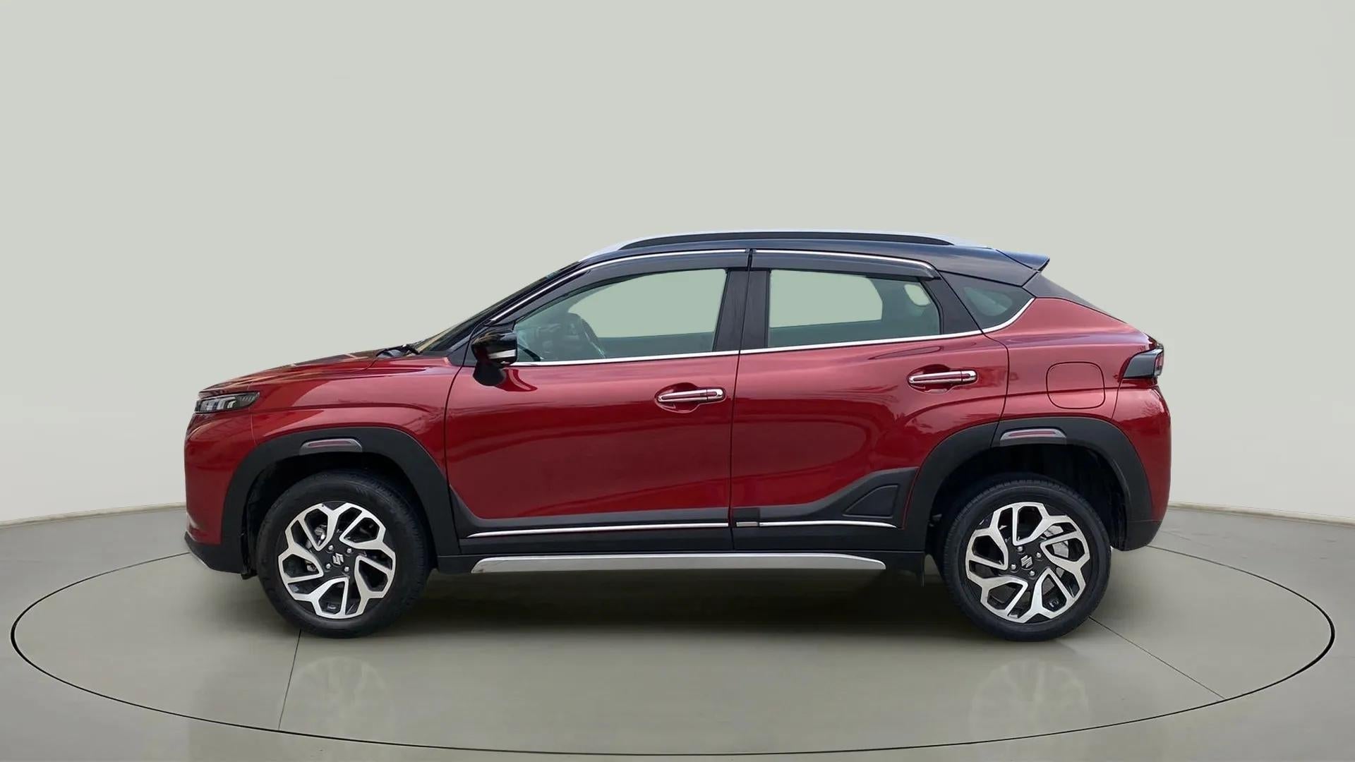 Side view of a Opulent Red with Blusih Black Maruti Suzuki FRONX