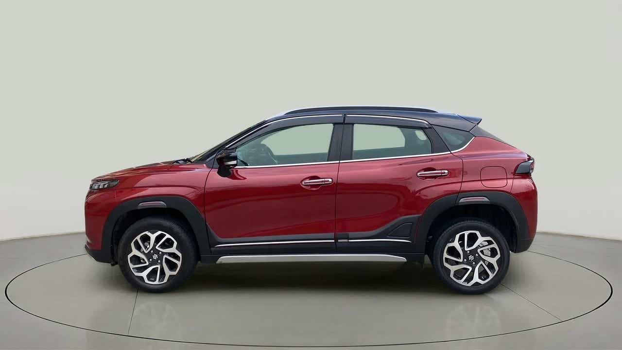 Side view of a Opulent Red with Blusih Black Maruti Suzuki FRONX