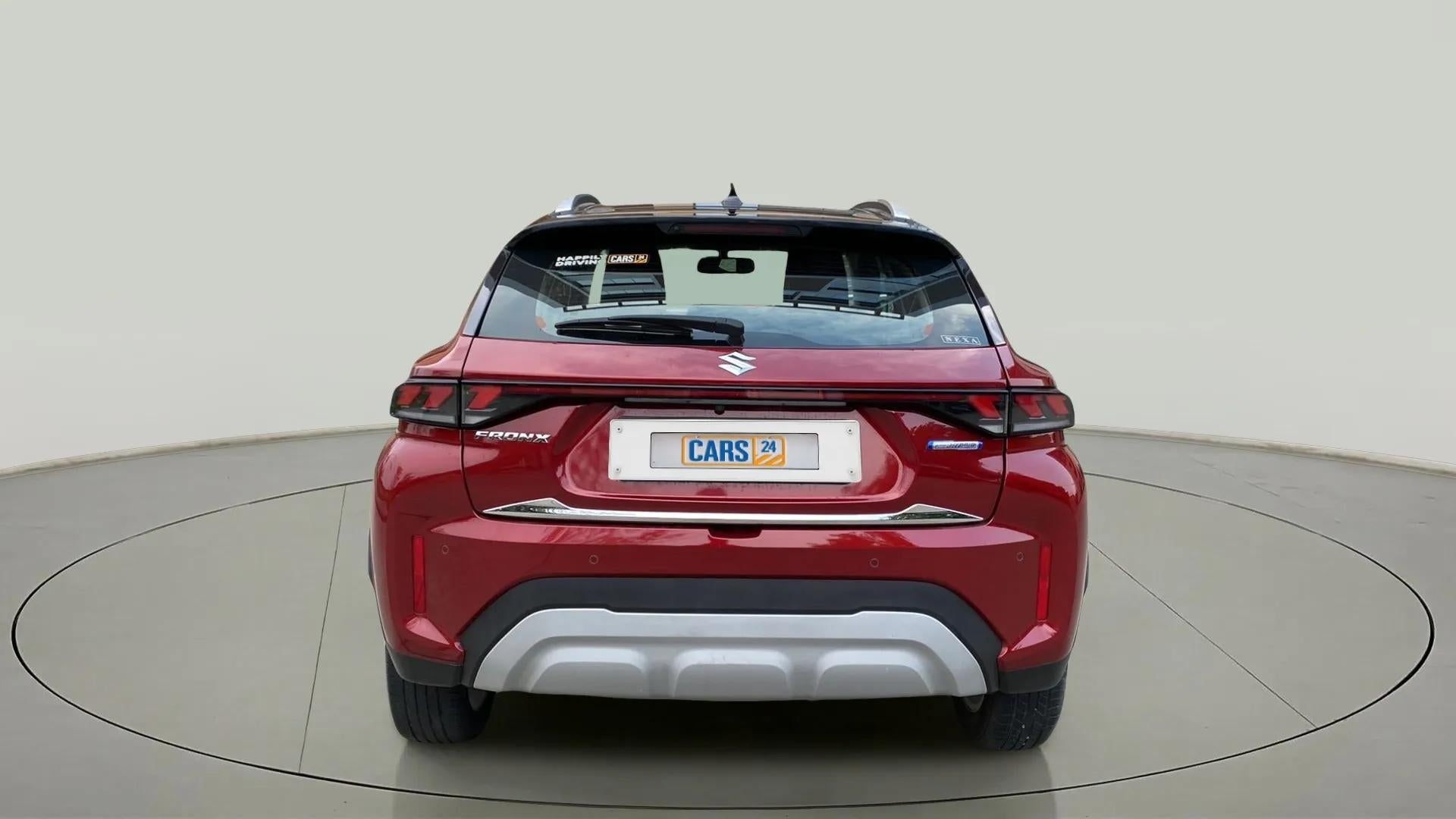 Rear view of a opulent red Maruti Suzuki FRONX