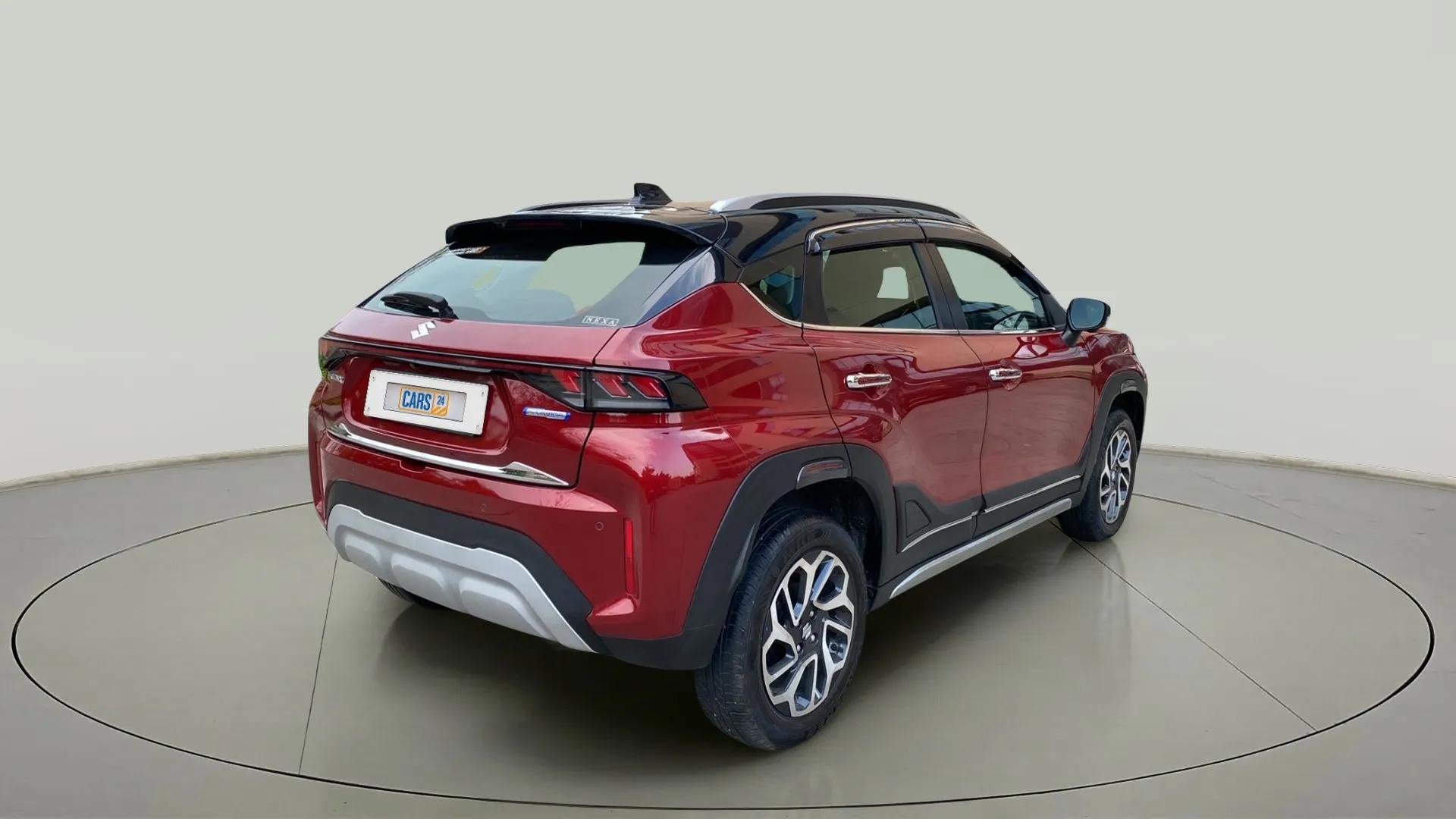 Rear three-quarter of a Opulent Red with Blusih Black Maruti Suzuki FRONX