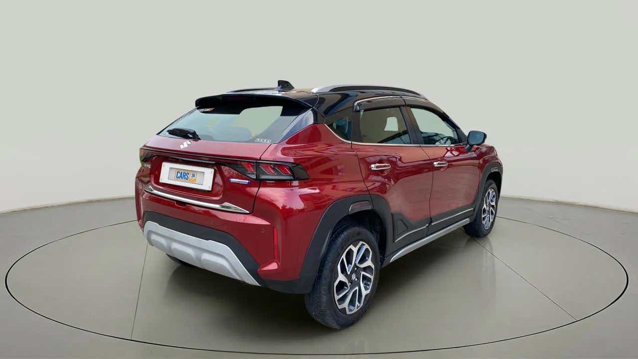 Rear three-quarter of a Opulent Red with Blusih Black Maruti Suzuki FRONX
