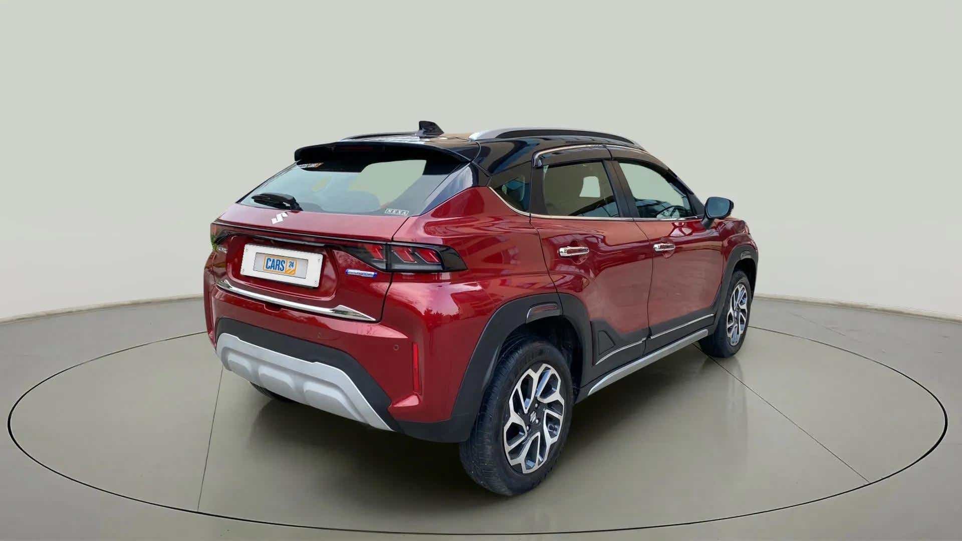 Rear three-quarter of a Opulent Red with Blusih Black Maruti Suzuki FRONX