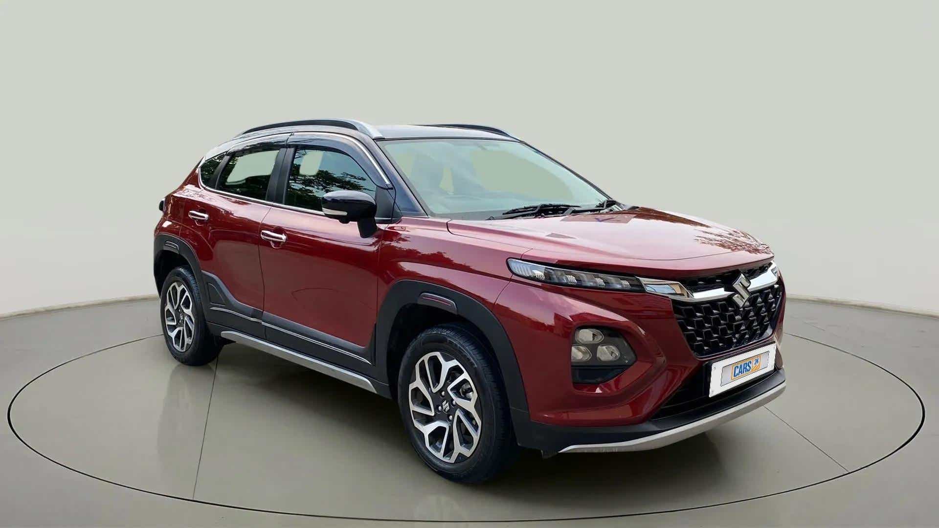 Front three-quarter view of a Opulent Red Maruti Suzuki FRONX