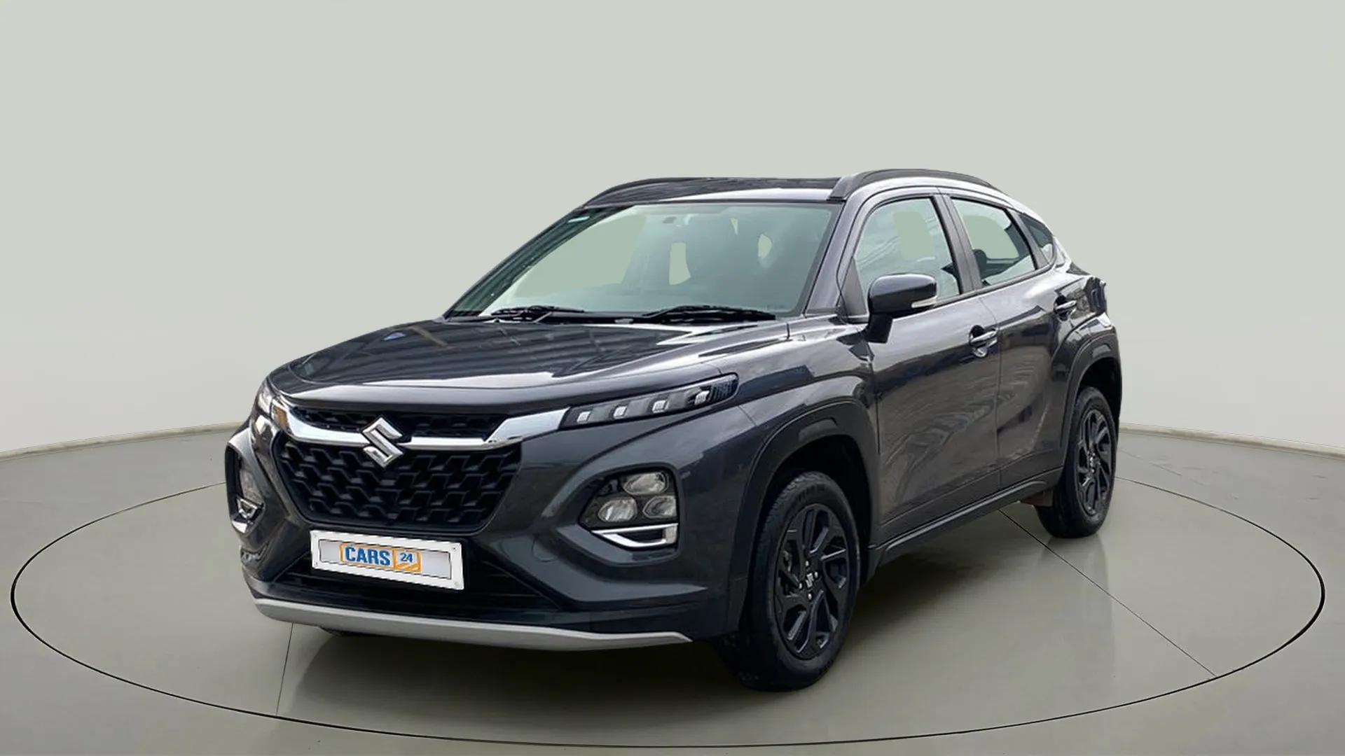 Front three-quarter view of a bluish black Maruti Suzuki FRONX