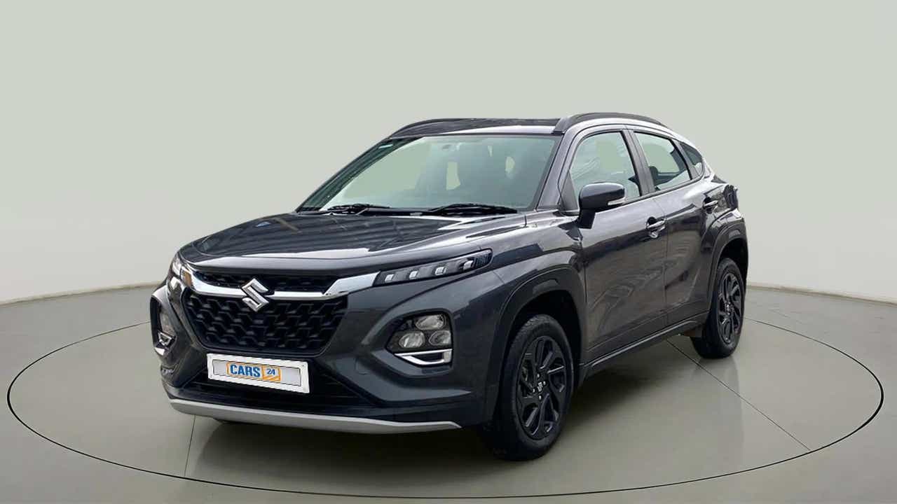 Front three-quarter view of a bluish black Maruti Suzuki FRONX