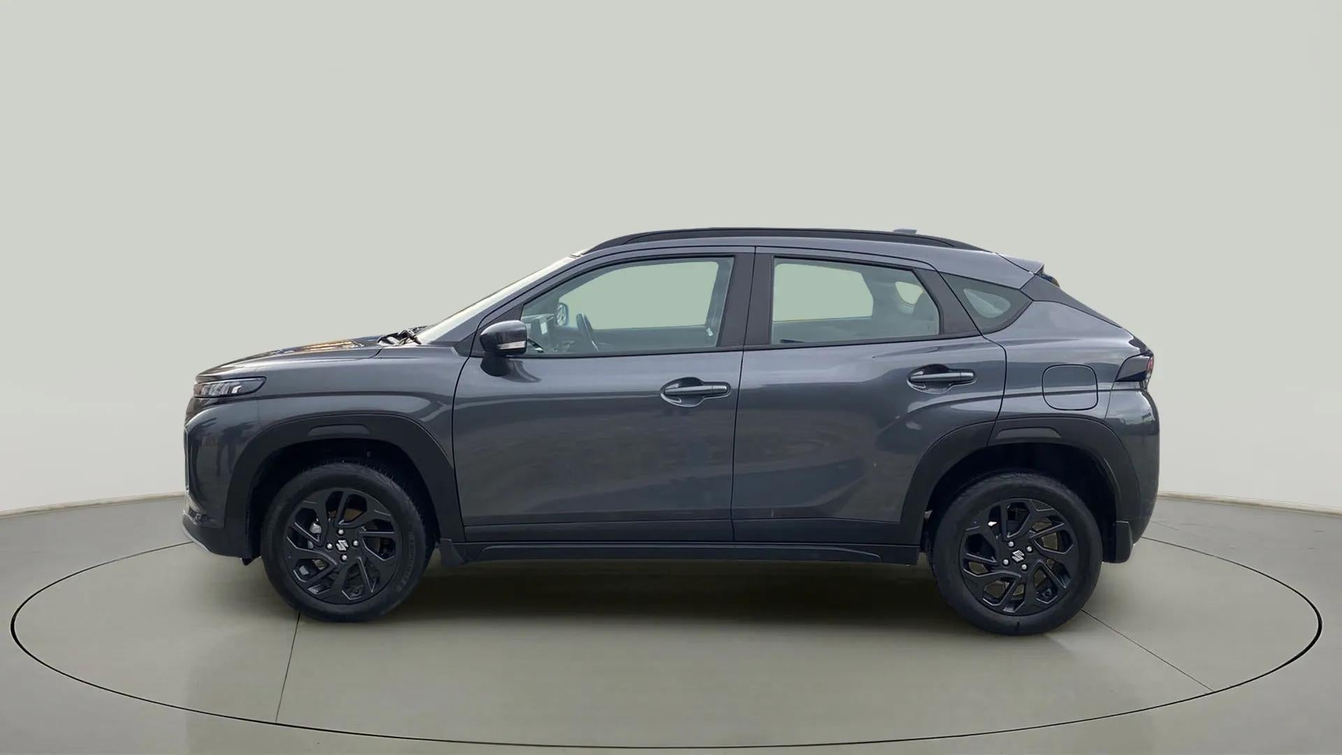 Side view of a Grandeur Grey Maruti Suzuki FRONX