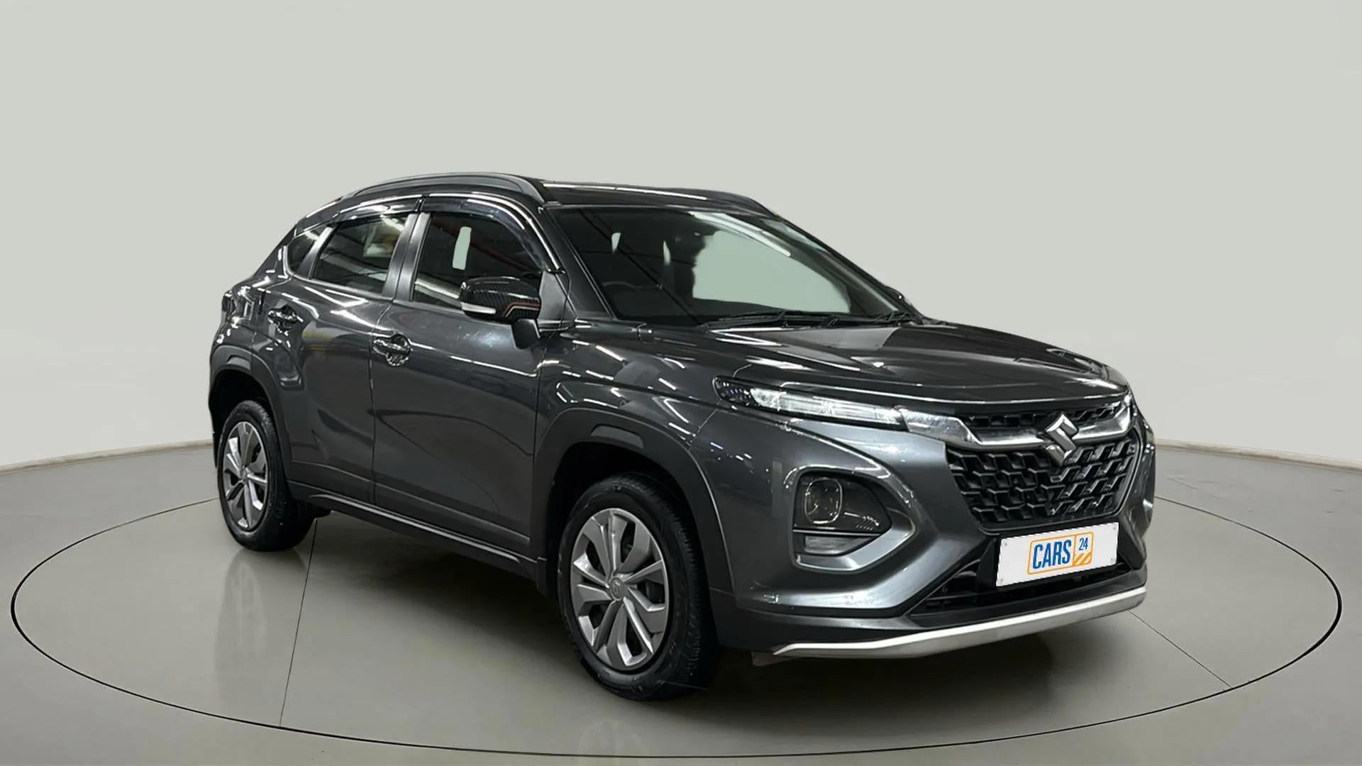 Front three-quarter view of a grandeur grey Maruti Suzuki FRONX