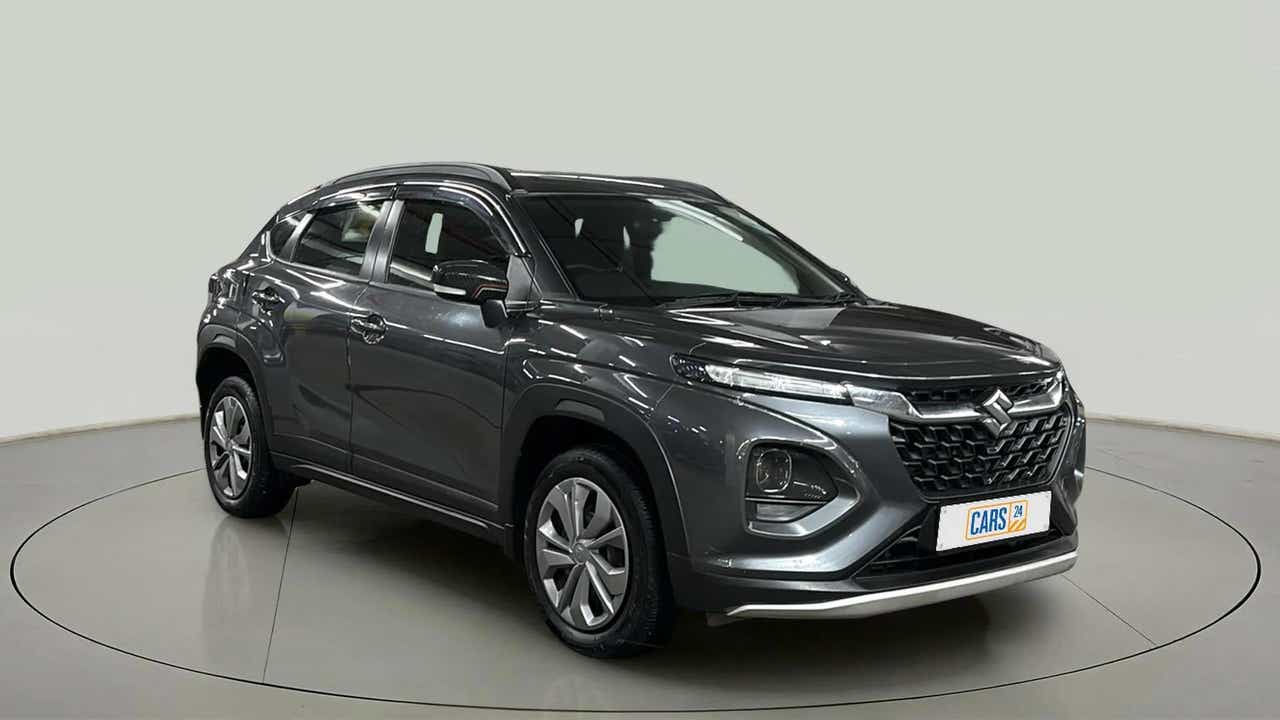 Front three-quarter view of a grandeur grey Maruti Suzuki FRONX