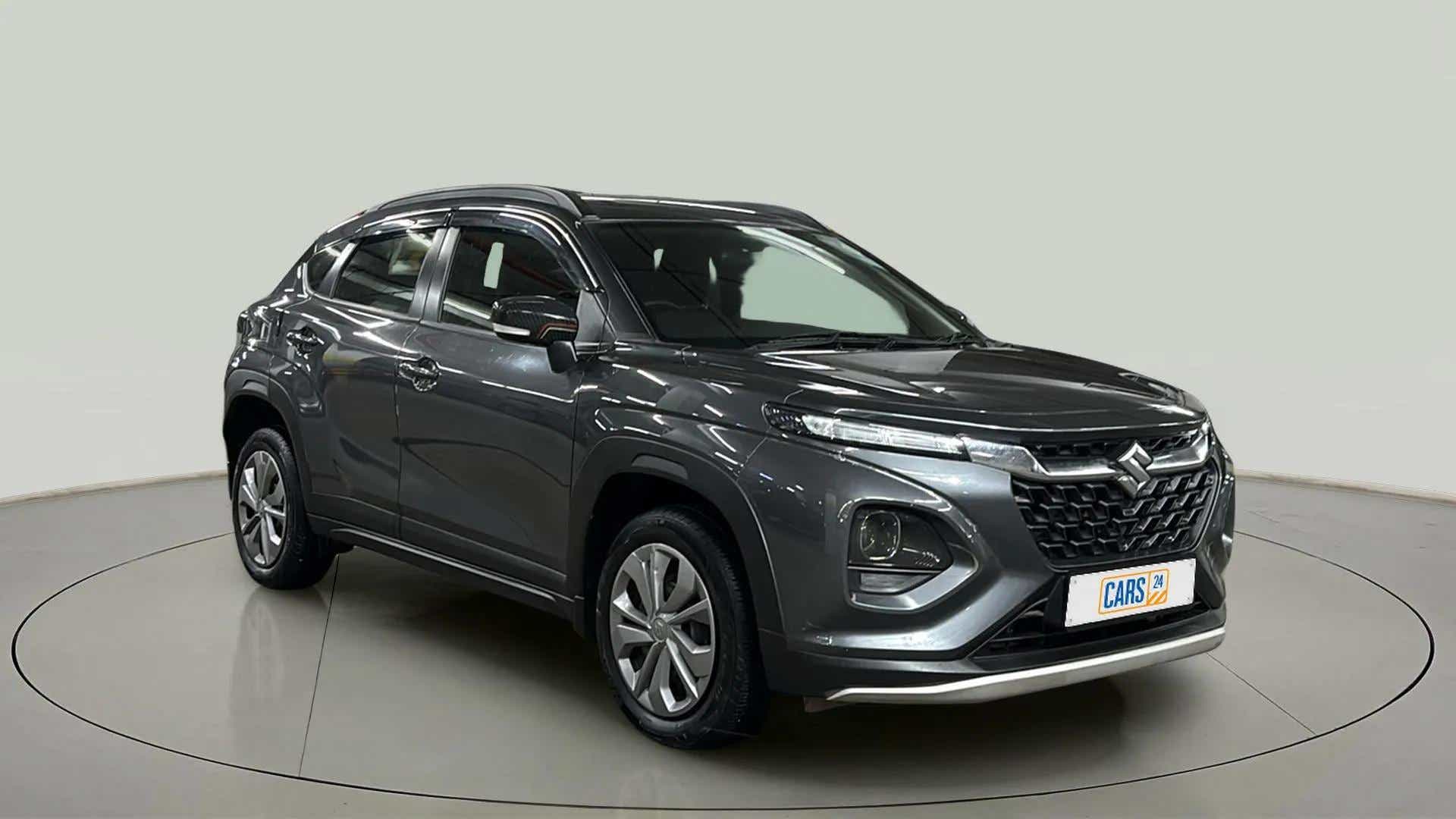 Front three-quarter view of a grandeur grey Maruti Suzuki FRONX