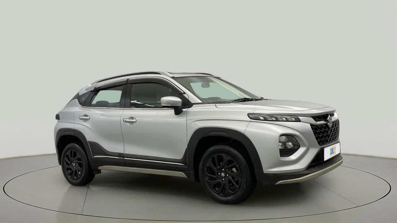 Front and side view of a Splendid Silver With Black Maruti Suzuki FRONX
