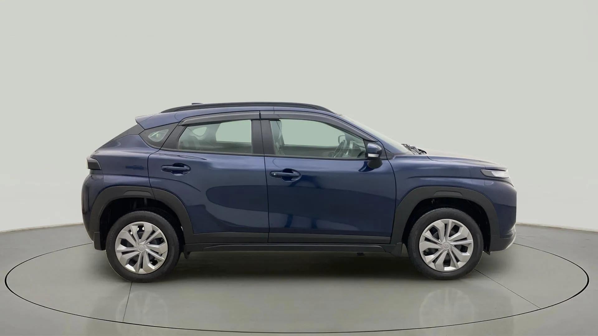 Side view of a Nexa Blue Maruti Suzuki FRONX