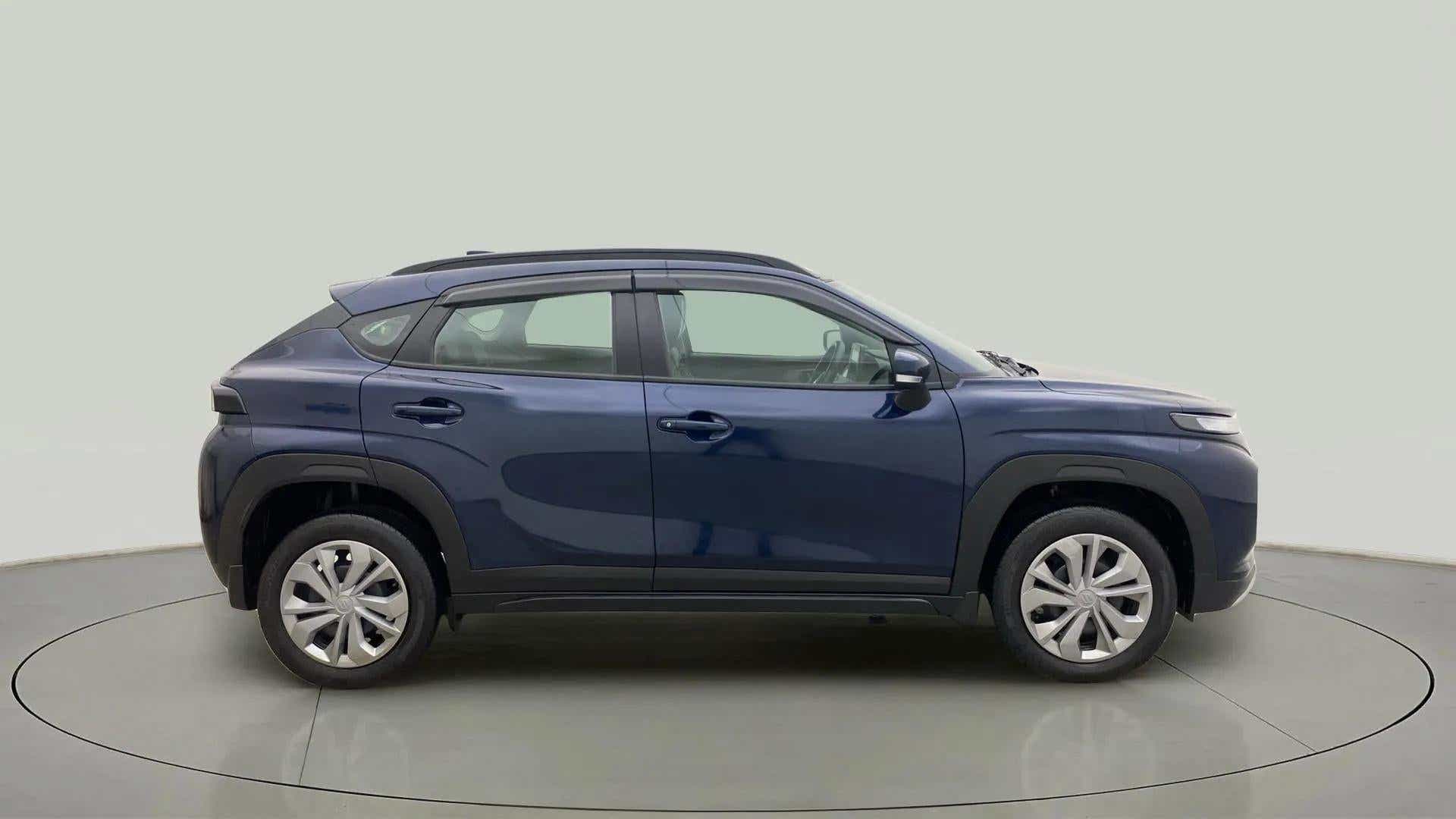 Side view of a Nexa Blue Maruti Suzuki FRONX