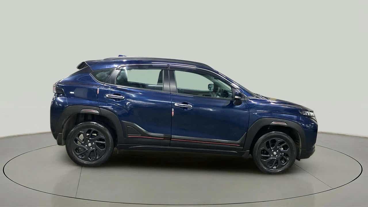 Side view of a Nexa Blue Maruti Suzuki FRONX