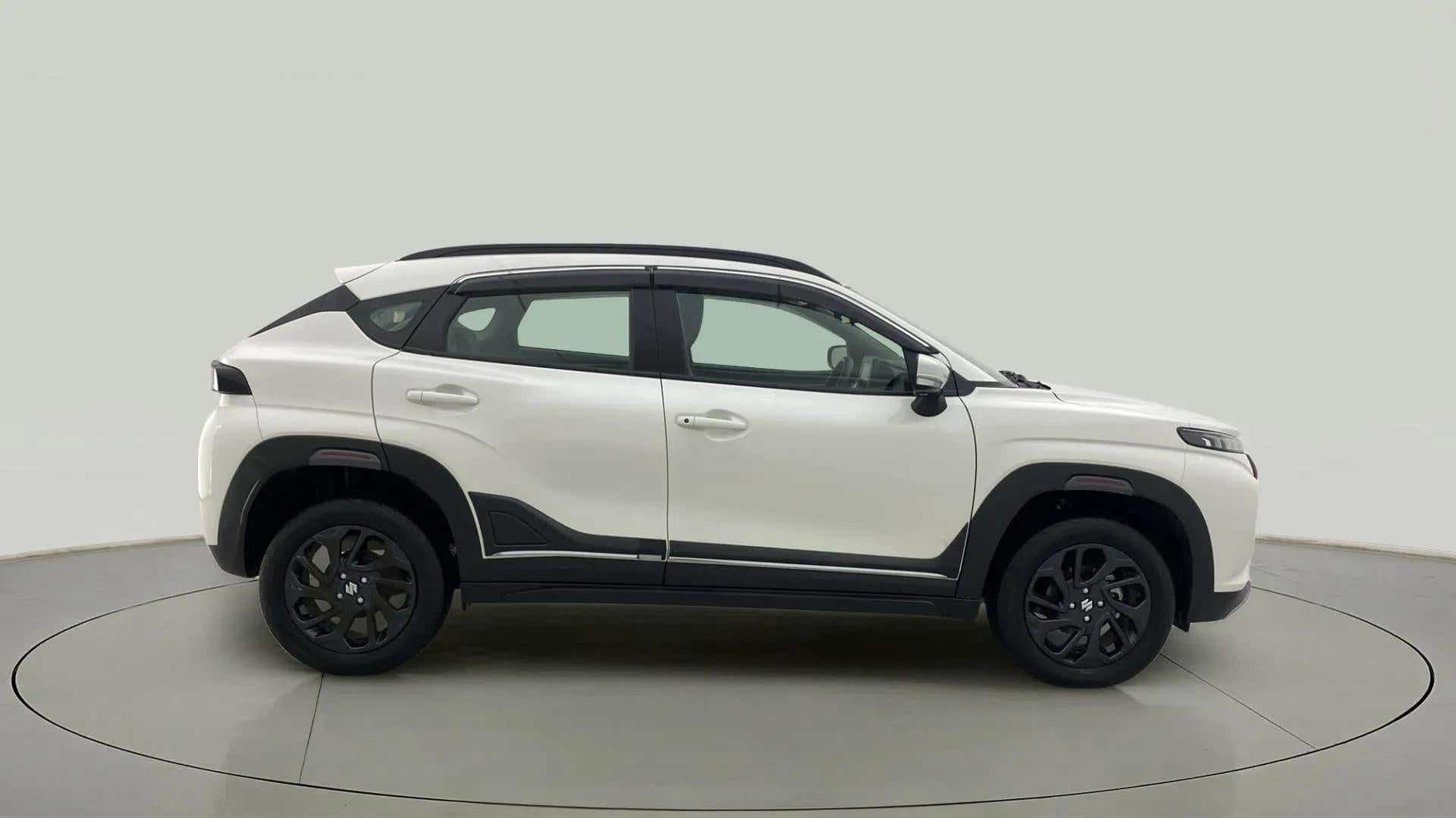 Side view of a arctic white Maruti Suzuki FRONX