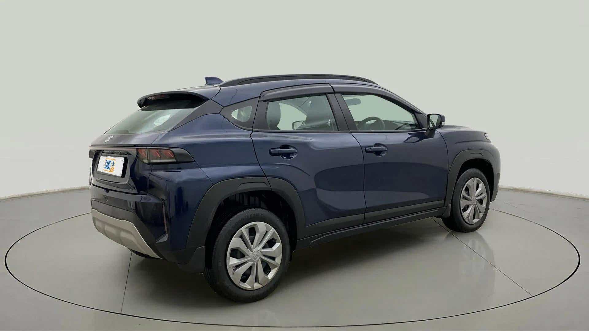 Rear three-quarter view of a Nexa Blue Maruti Suzuki FRONX