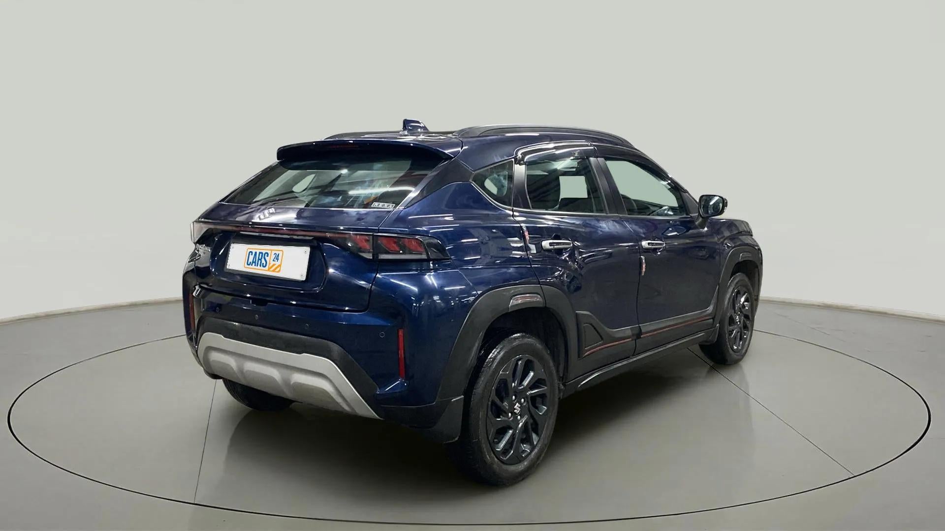 Rear three-quarter view of a Nexa Blue Maruti Suzuki FRONX