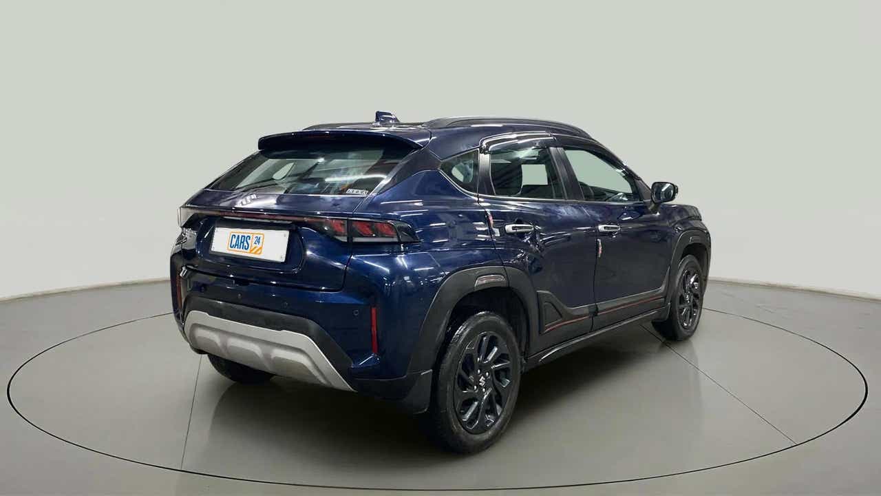 Rear three-quarter view of a Nexa Blue Maruti Suzuki FRONX