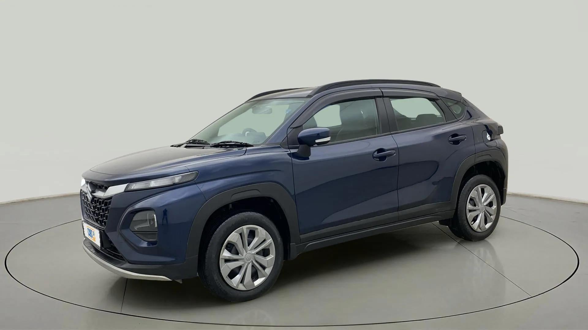 Front three quarter view of a Nexa Blue Maruti Suzuki FRONX