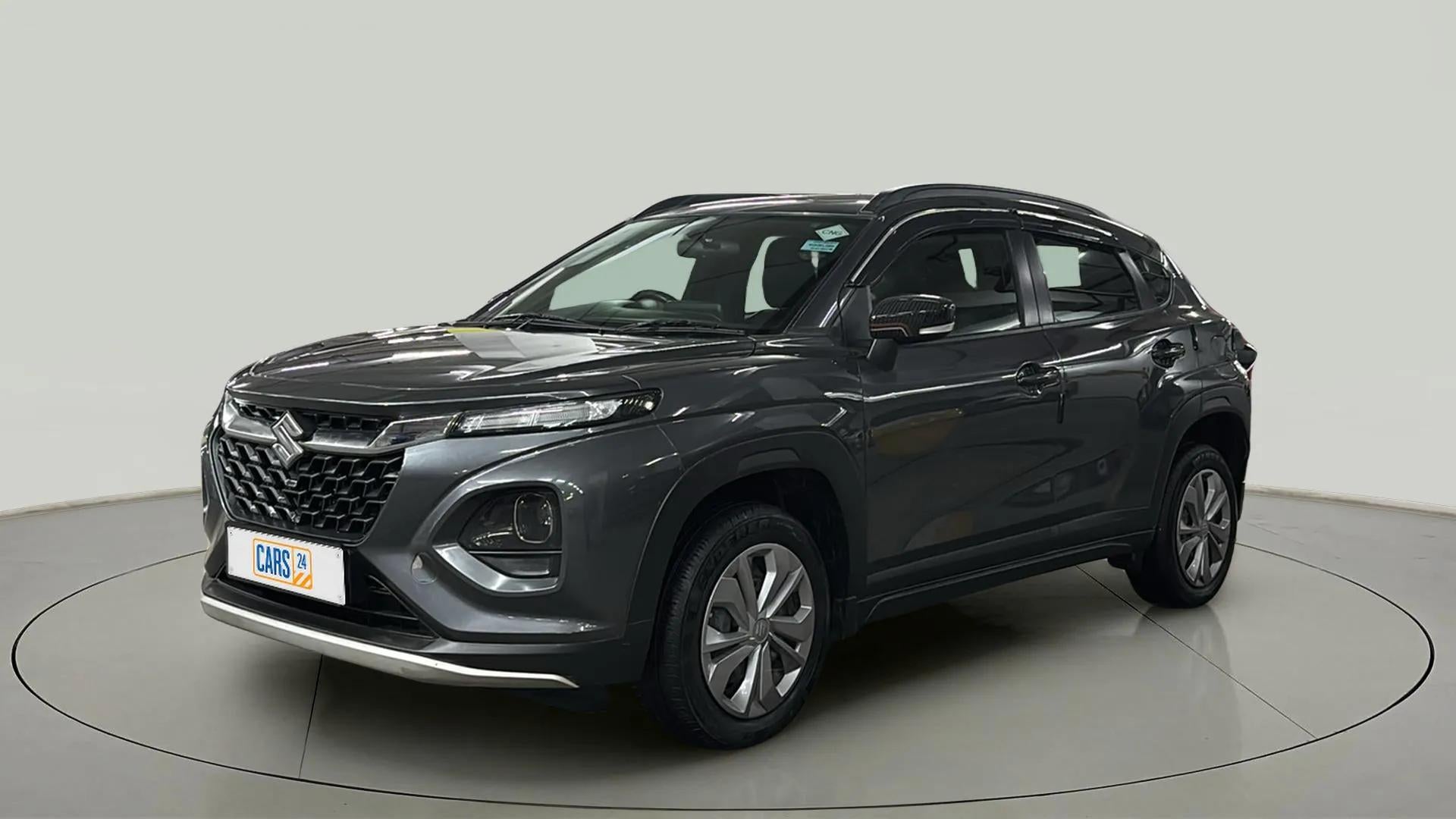 Front three quarter view of a Grandeur Grey Maruti Suzuki FRONX