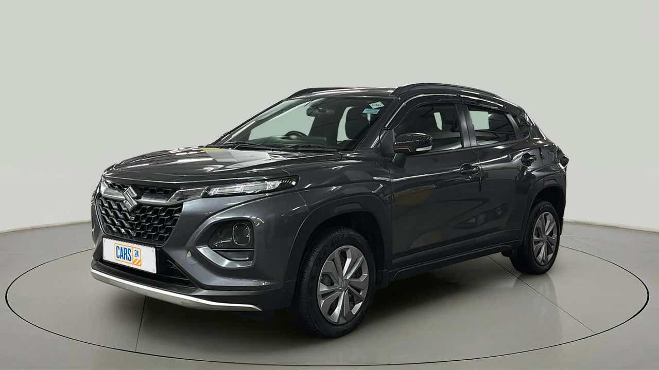 Front three quarter view of a Grandeur Grey Maruti Suzuki FRONX